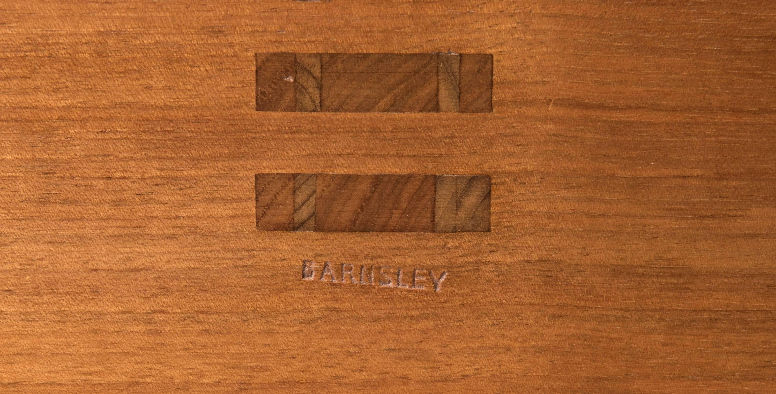 A lovely walnut dining table by Edward Barnsley of wishbone form.
The elliptical top quartered veneered.
Set with simple boxwood inlay bands
England
circa 1971
Stamped Barnsley
Made for a wedding present.
Measures: 230 cm wide x 108 cm wide x 74 cm