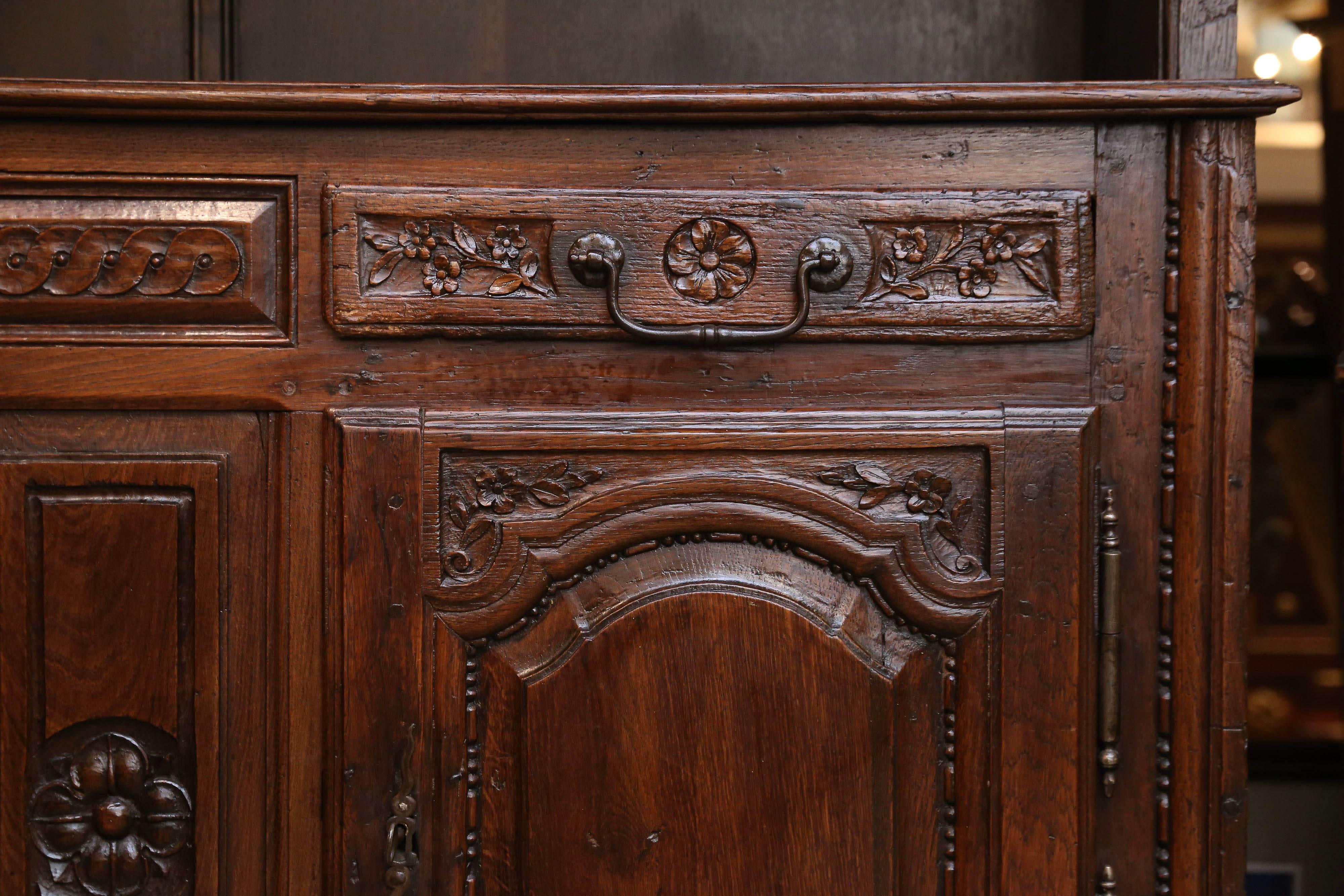 Lovely 18th century country French cupboard having two lower doors opening
to storage area. Two drawers with original hand-wrought drawer pulls are
under the upper structure which holds three addition decorative shelves
for display. Louis XV