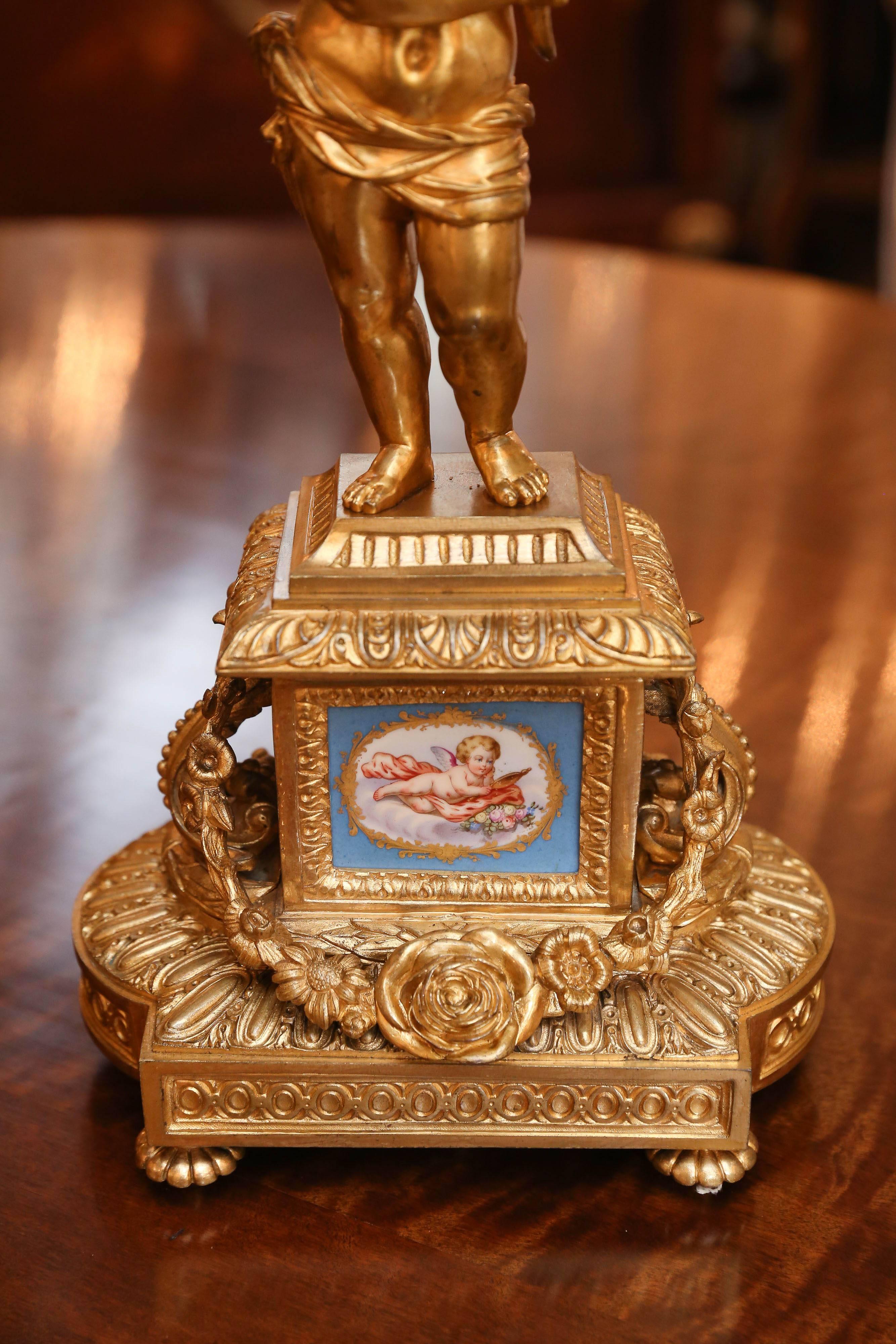 Beautiful pair of doré bronze candelabrum, 19th century. Putto holding
The candelabrum each with six candleholders. Sevres style  porcelain mounts
In Celeste blue.