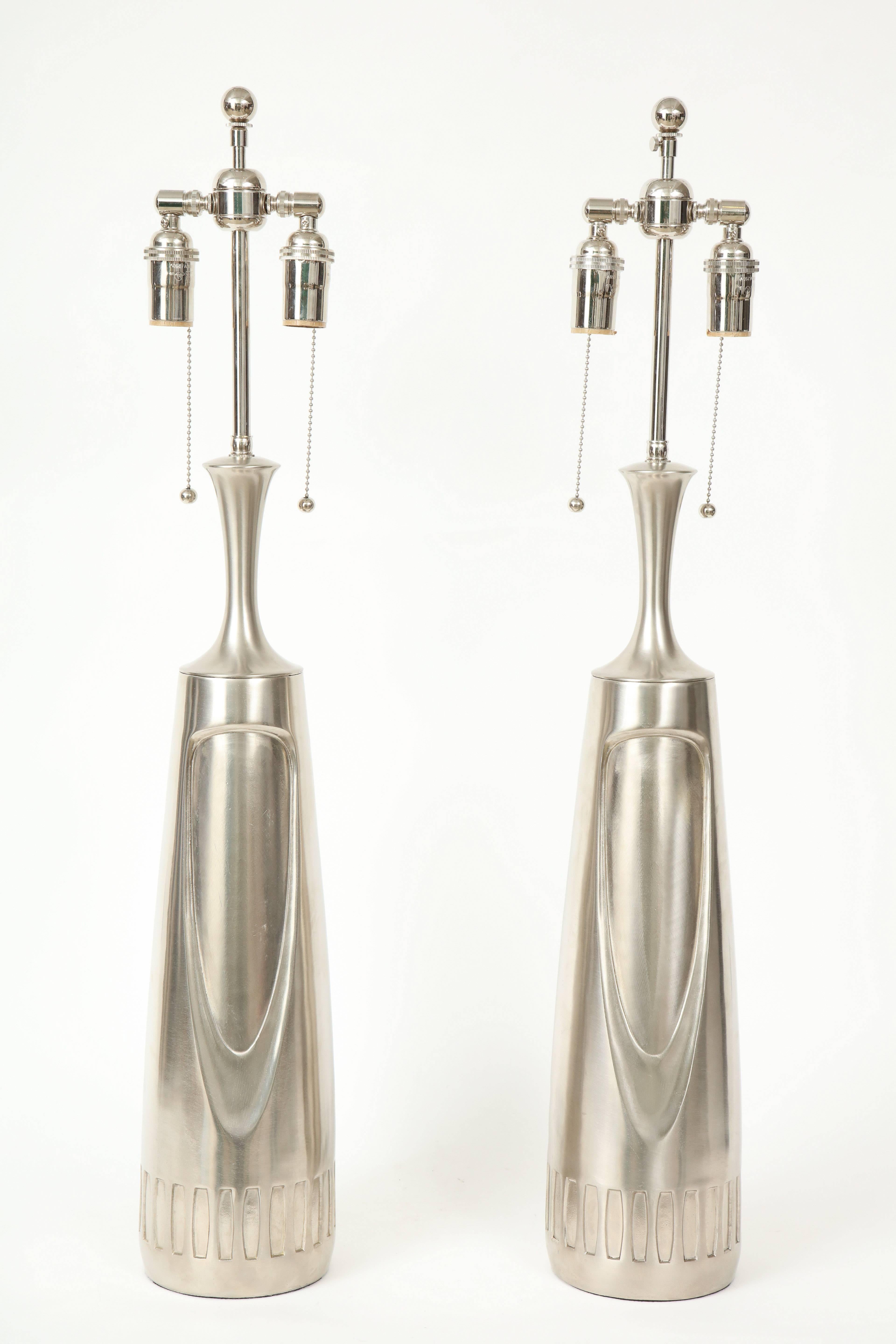 Pair of 1970s laurel lamps with a brushed aluminium finish.
The lamps have a recessed design to the front and rear.
They have been newly rewired for the US with chrome double clusters that take standard light bulbs.
The height to the top of the