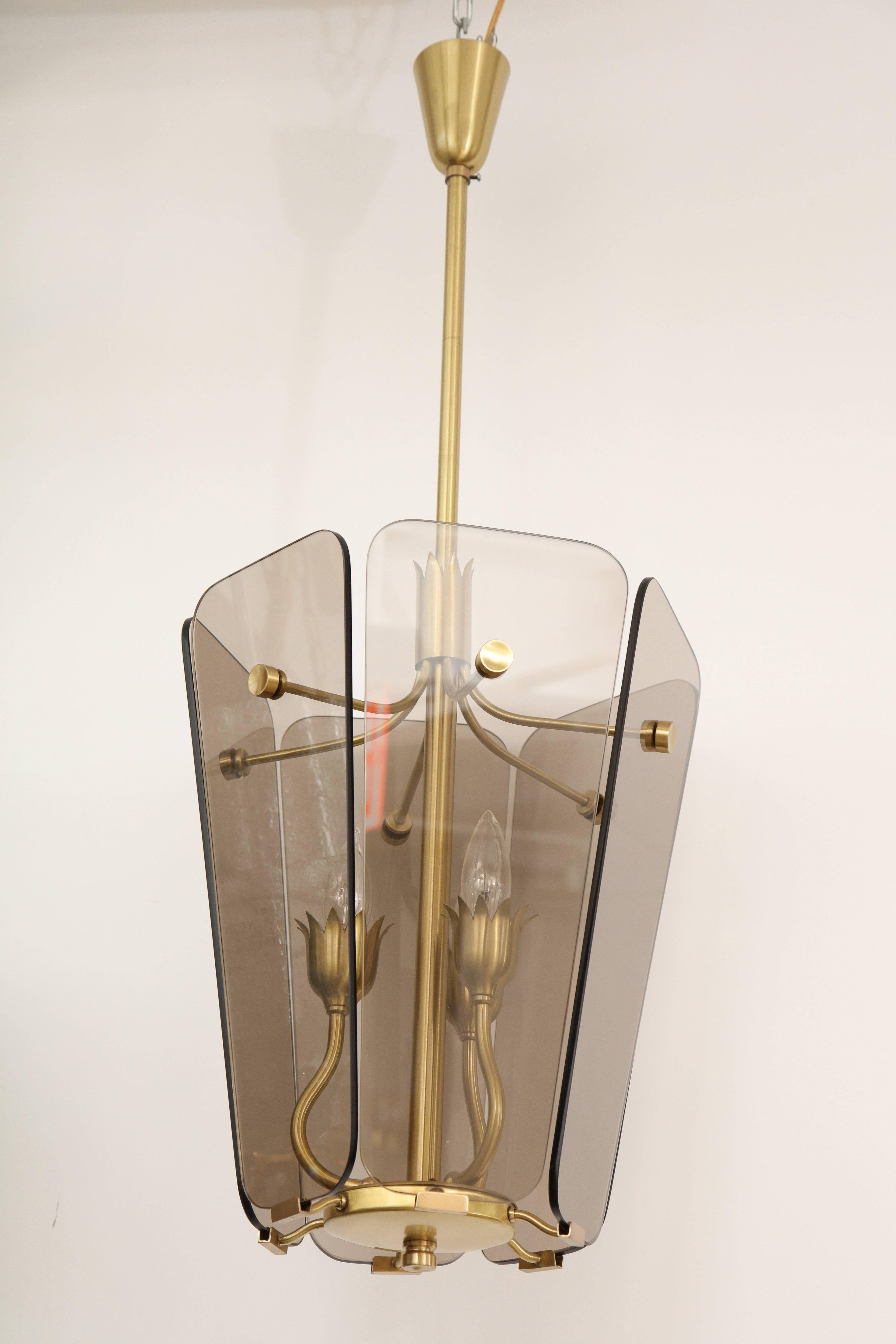 Mid-Century Italian satin brass framed pendant chandelier with six smoked glass panels. Pendant houses three-light sources and has been rewired for use in the USA. Lantern body measures 17.5 inches tall.