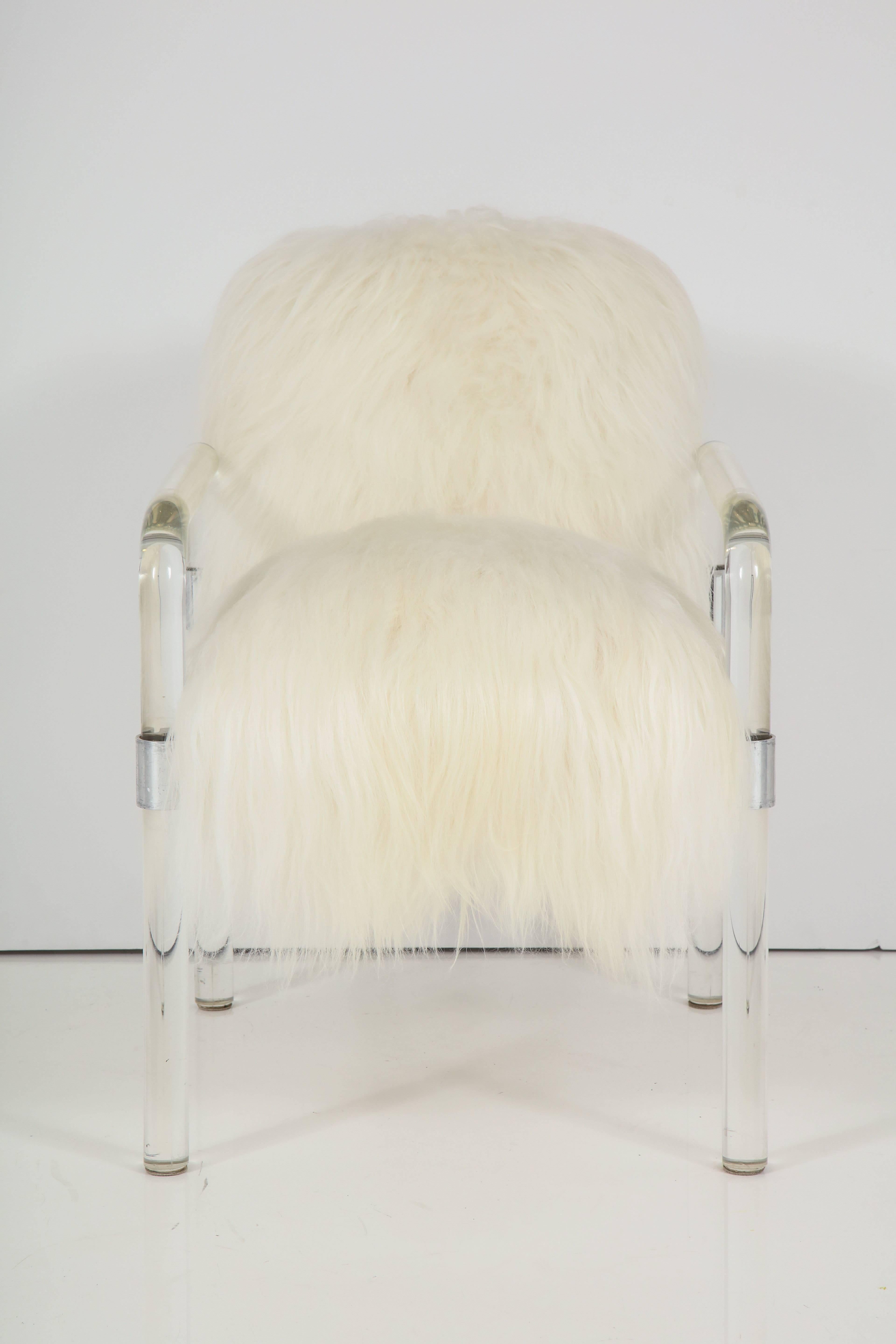 Pair of Pipeline series Lucite arm chairs designed by Jeff Messerschmidt in luxurious pure white long hair Arctic sheepskin. Upholstery is dense and extremely soft. Currently there is a pair available, $3400 each.