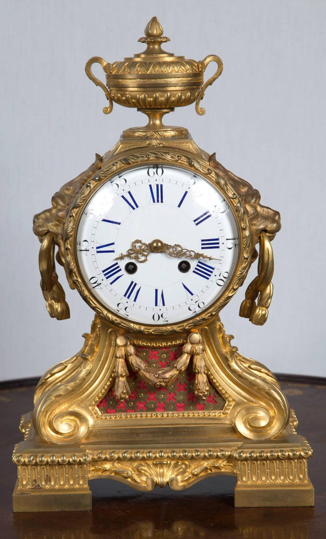 Porcelain dial with blue roman numerals and black Arabic on the outer edge. Gilt bronze case after a design by Le Duc, circa 1770. Red cloth behind cut brass. The case in mercury gilt.
Works are signed Rollin (19th century replacements)
Design for