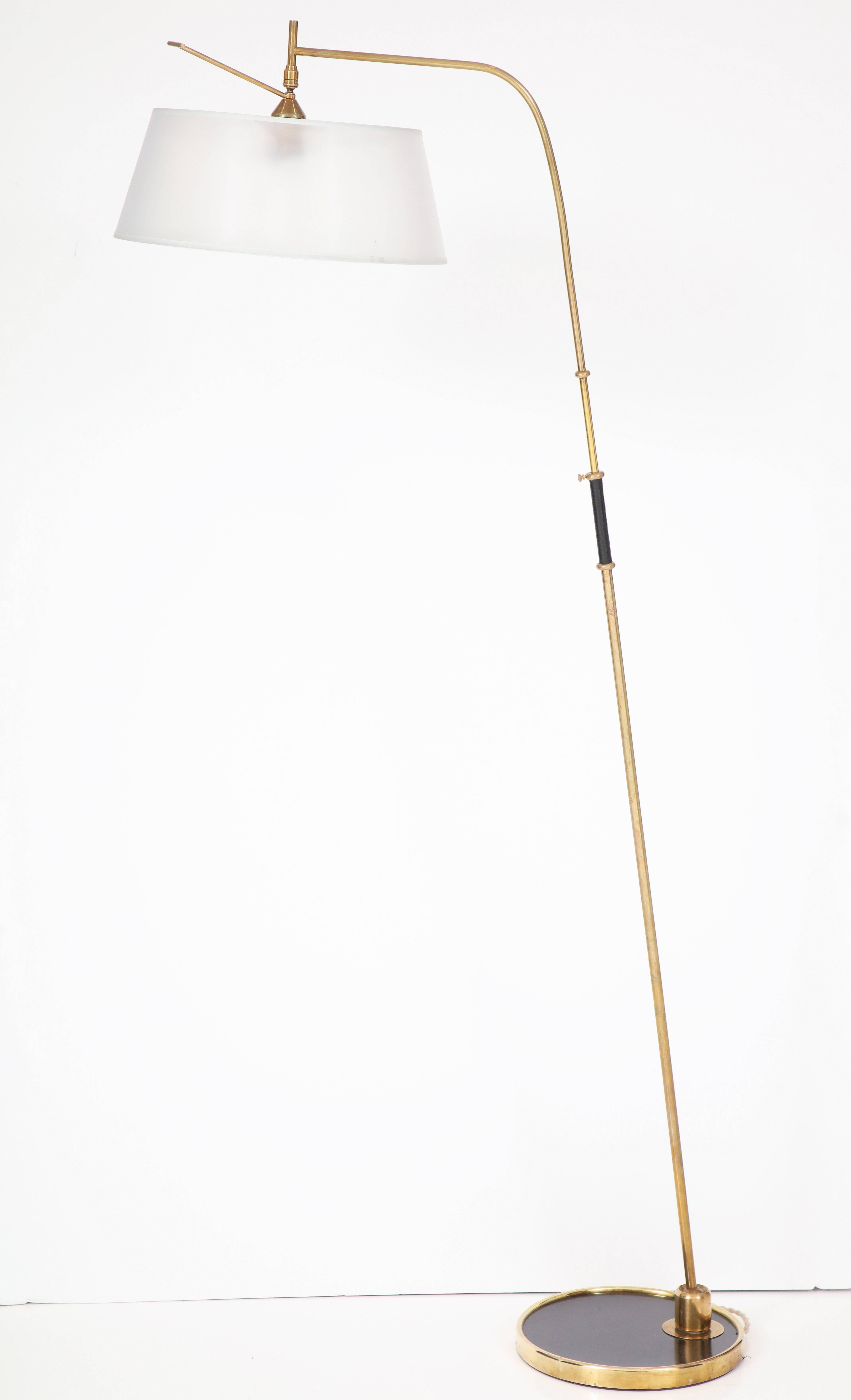 French Maison Lunel articulating floor lamp in brass. Articulating shade and shaft rotates 360, can achieve very dramatic angles in any direction forward, back, side to side.  The shaft is mounted to a ball socket which allows full circular