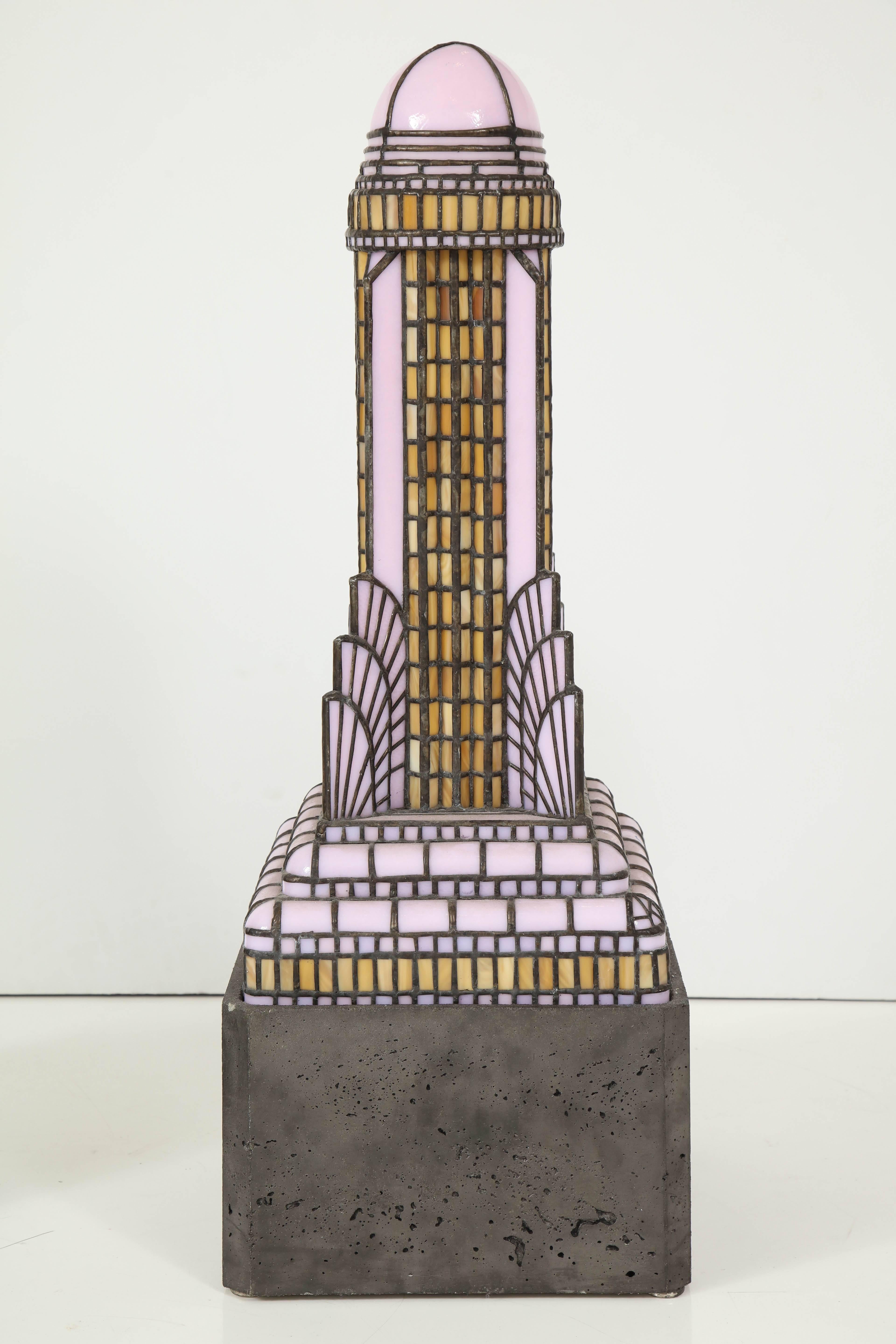 Light fixture sculpture by artist Adam Kurtzman of the Chrysler Building, New York City. USA, 2016. Stained glass (pink/mustard yellow) and metal light on concrete lighted base. Takes a U.S. bulb. May be viewed at the Metropolis Modern showroom at
