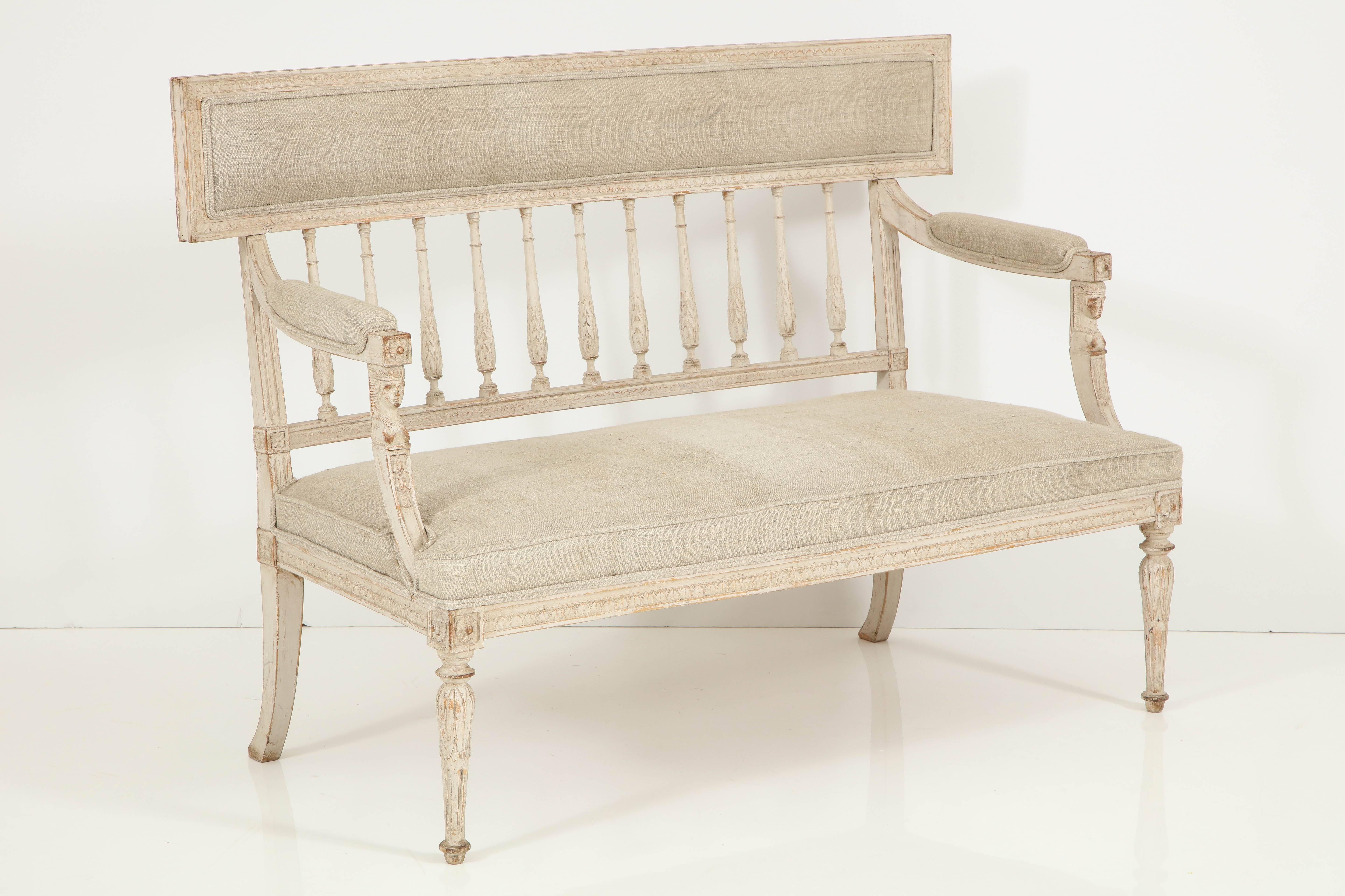 Refined and elegant, this charming settee would be perfect in an entry, a bedroom or just about anywhere.  The piece features lovely, detailed hand carving on the arm supports, apron and die joins.  The spindle back has an upper solid back rest;