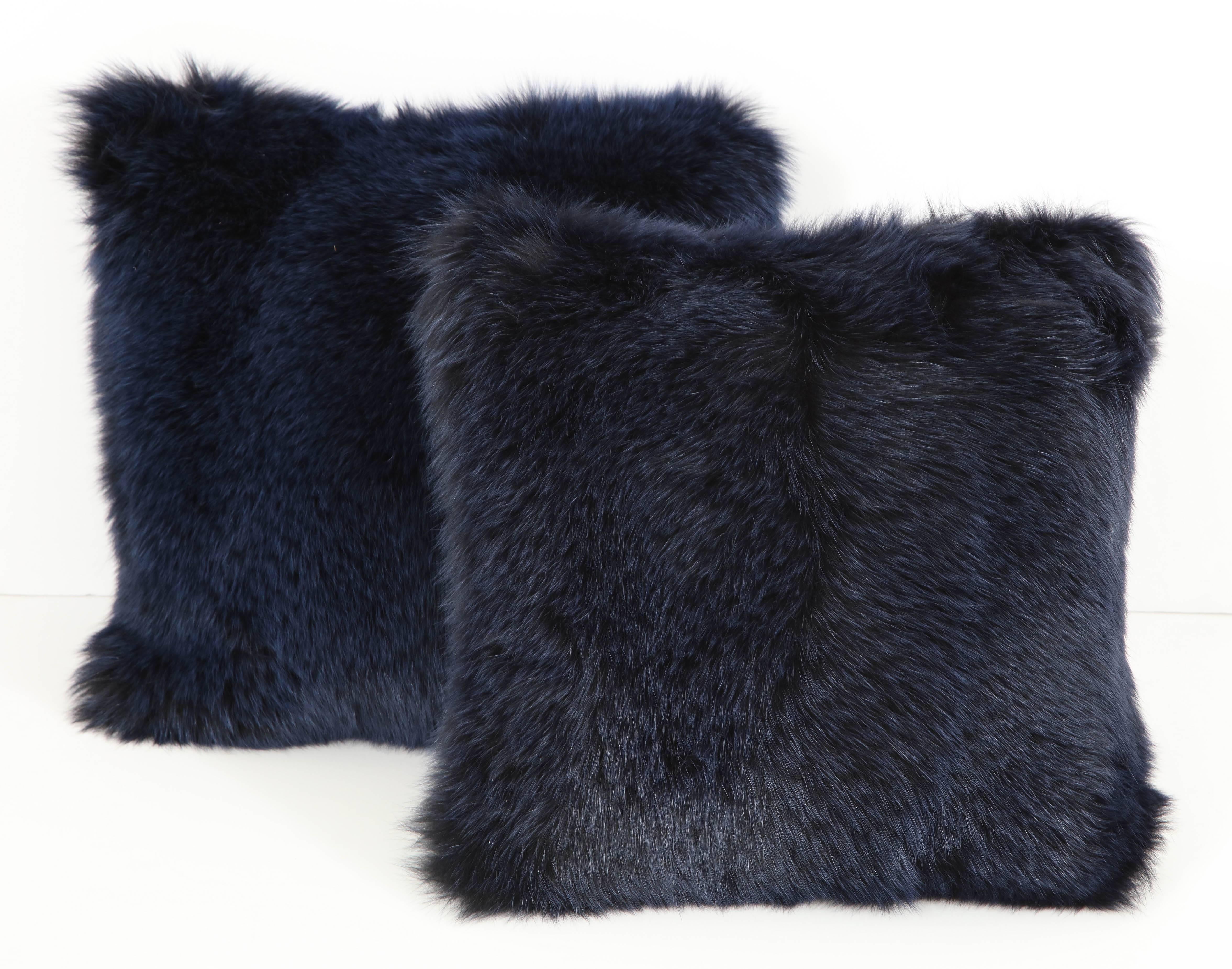 A pair of glamorous and luxurious fox fur pillows in a dramatic midnight blue, backed in navy cashmere. The perfect finishing touch to a room!