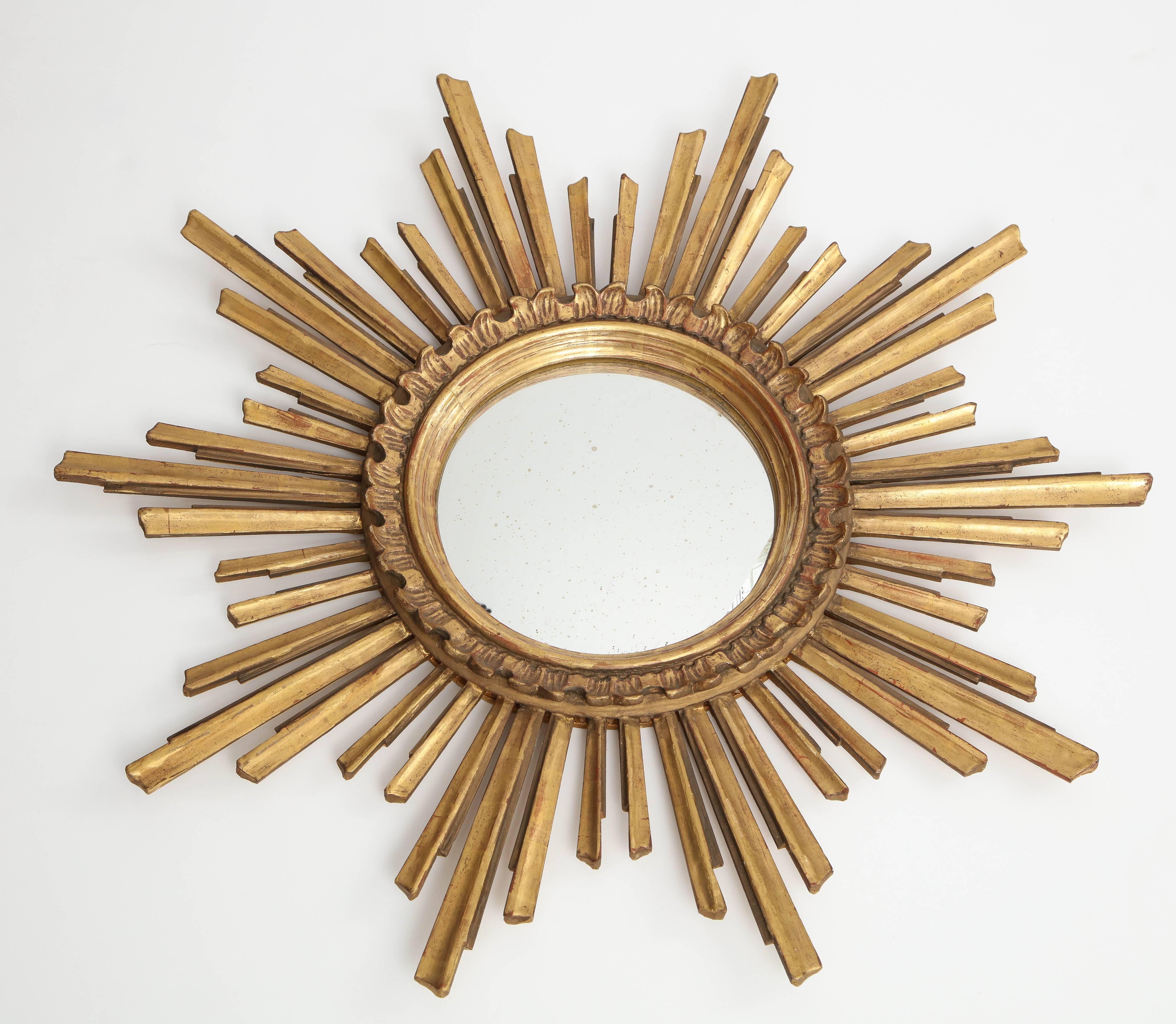 This is a particularly attractive sunburst mirror, with its beautiful patina, variegated rays and double molded centre ring. Made in France in the 1970s.