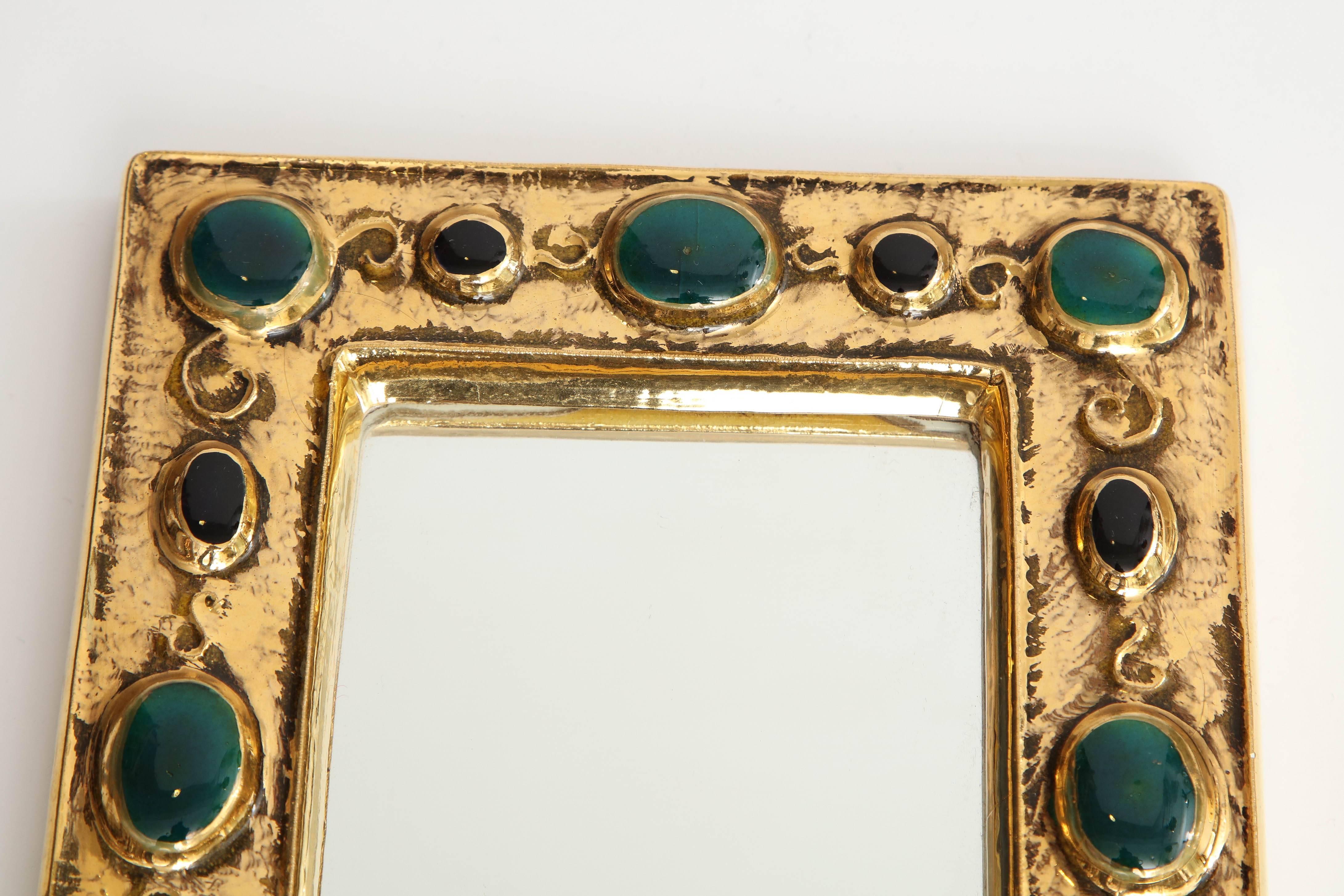 A beautiful and charming mirror designed by French artist Francois Lembo. Composed of a crackled gold glaze frame, the mirror features a design of 