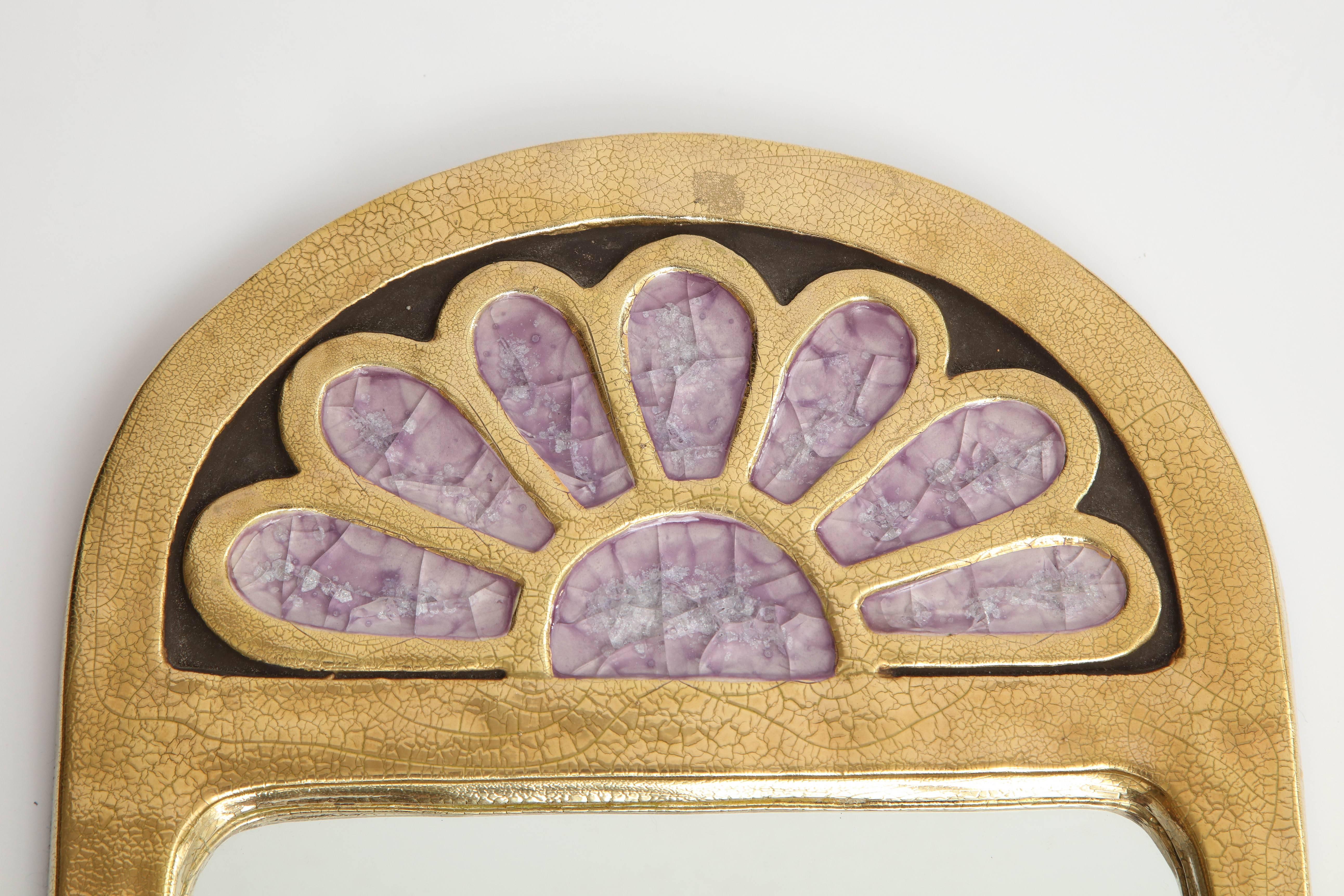 Inspired by Russian icons, Francois Lembo's creations are unique and beautiful works of art. This charming mirror features a frame in a gold crackled glaze surmounted by a flower motif in a lavender stone. Simple and stunning, this piece can go on
