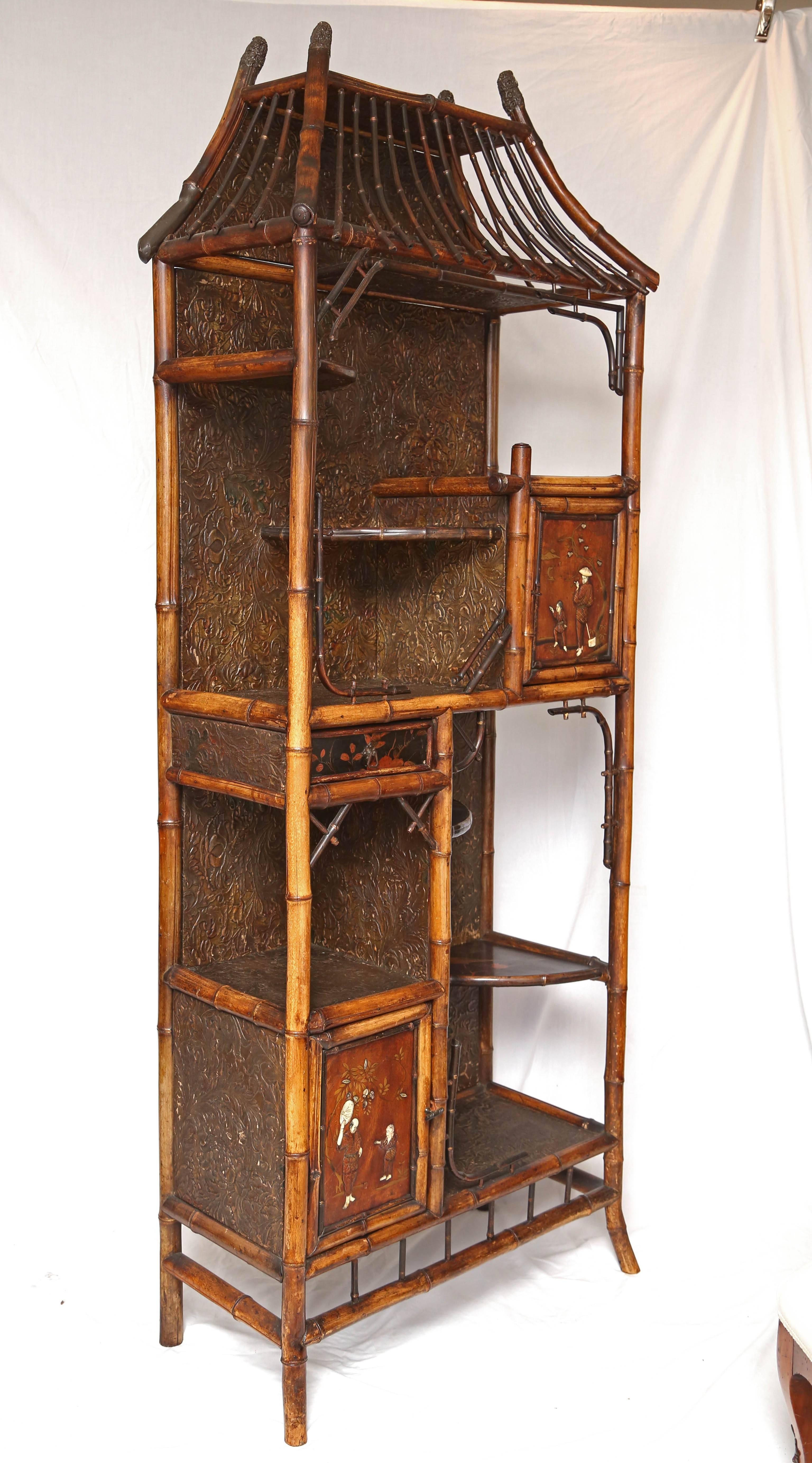 Superb 19th century English Japanese bamboo étagère recover with leather paper, carved doors and lacquer shelves.
This is truly a Museum piece!