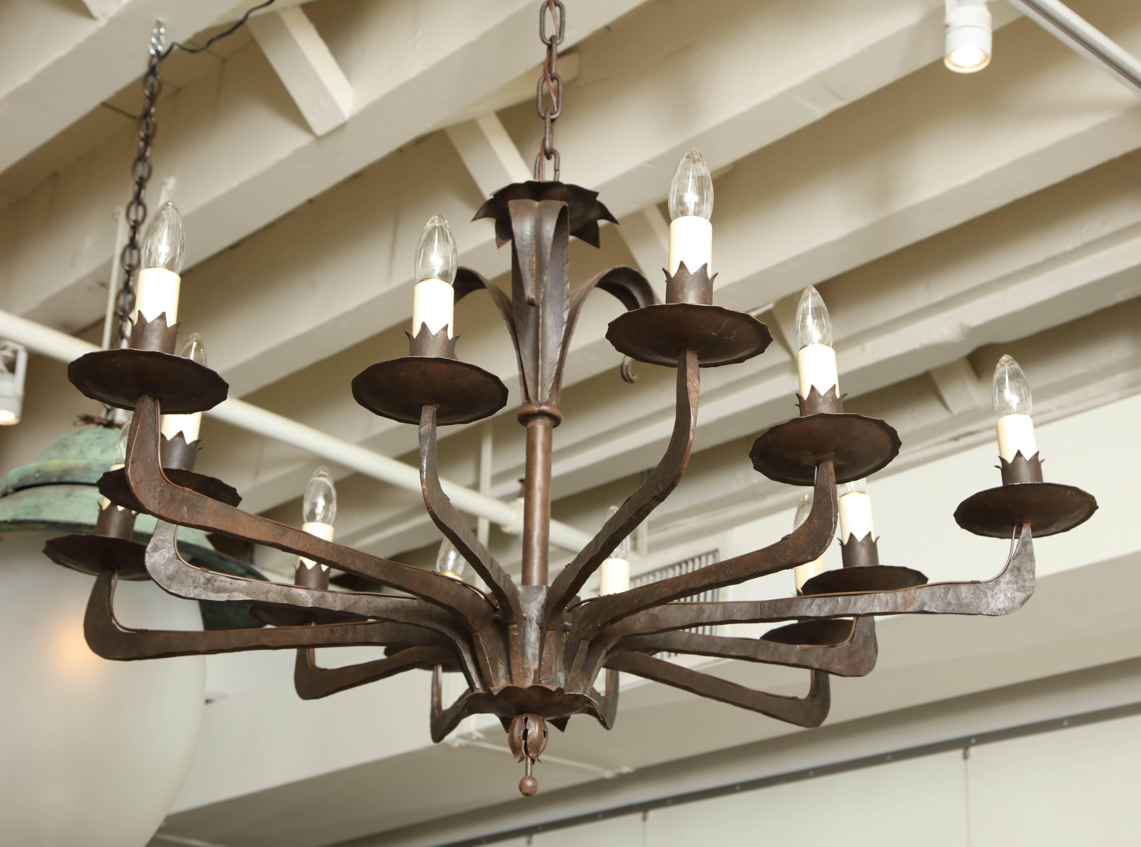 Twelve-arm iron chandelier with foliate motif. Recently rewired for US specifications.

