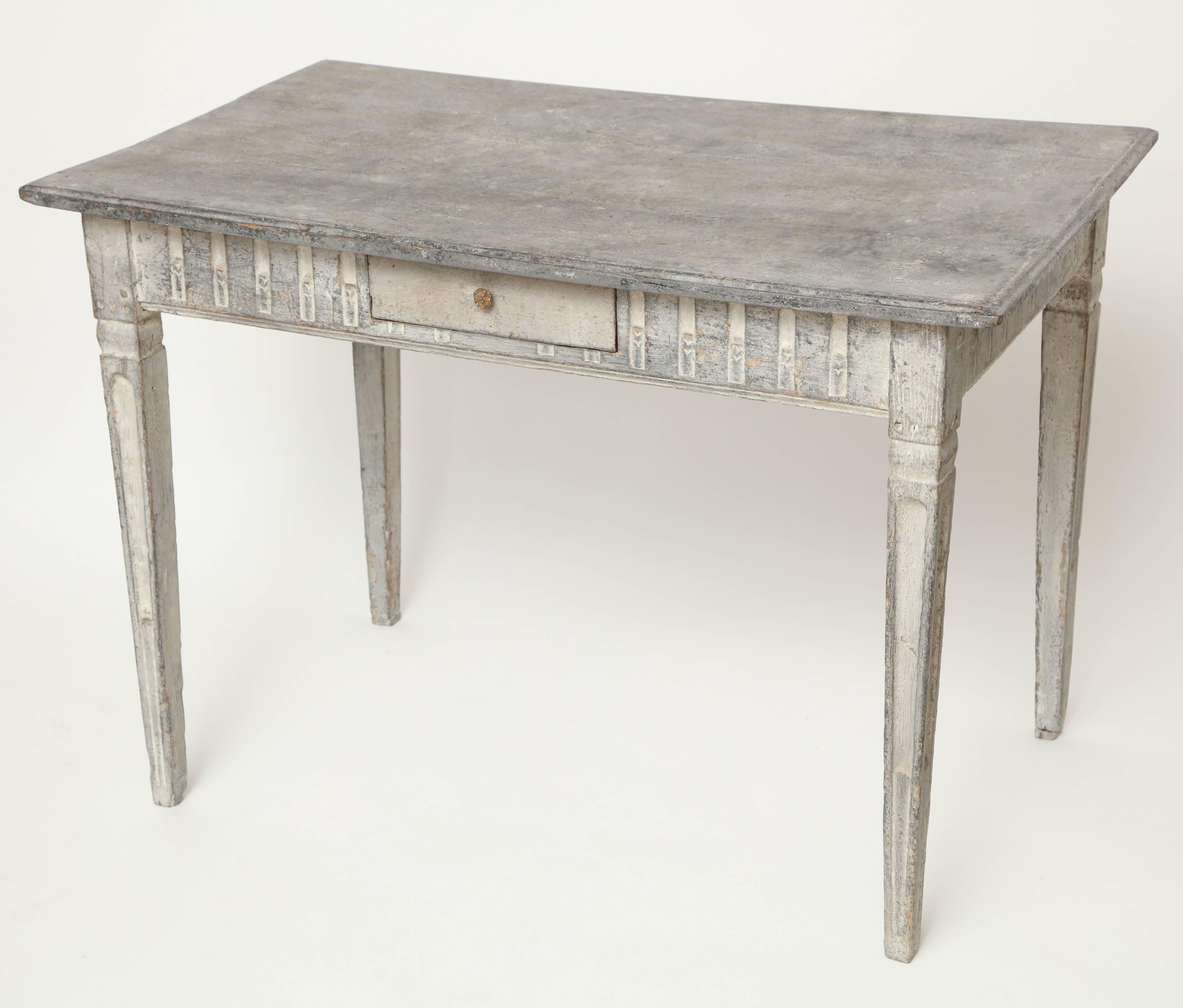 Carved and painted table with single drawer and tapered legs, France, circa 1800