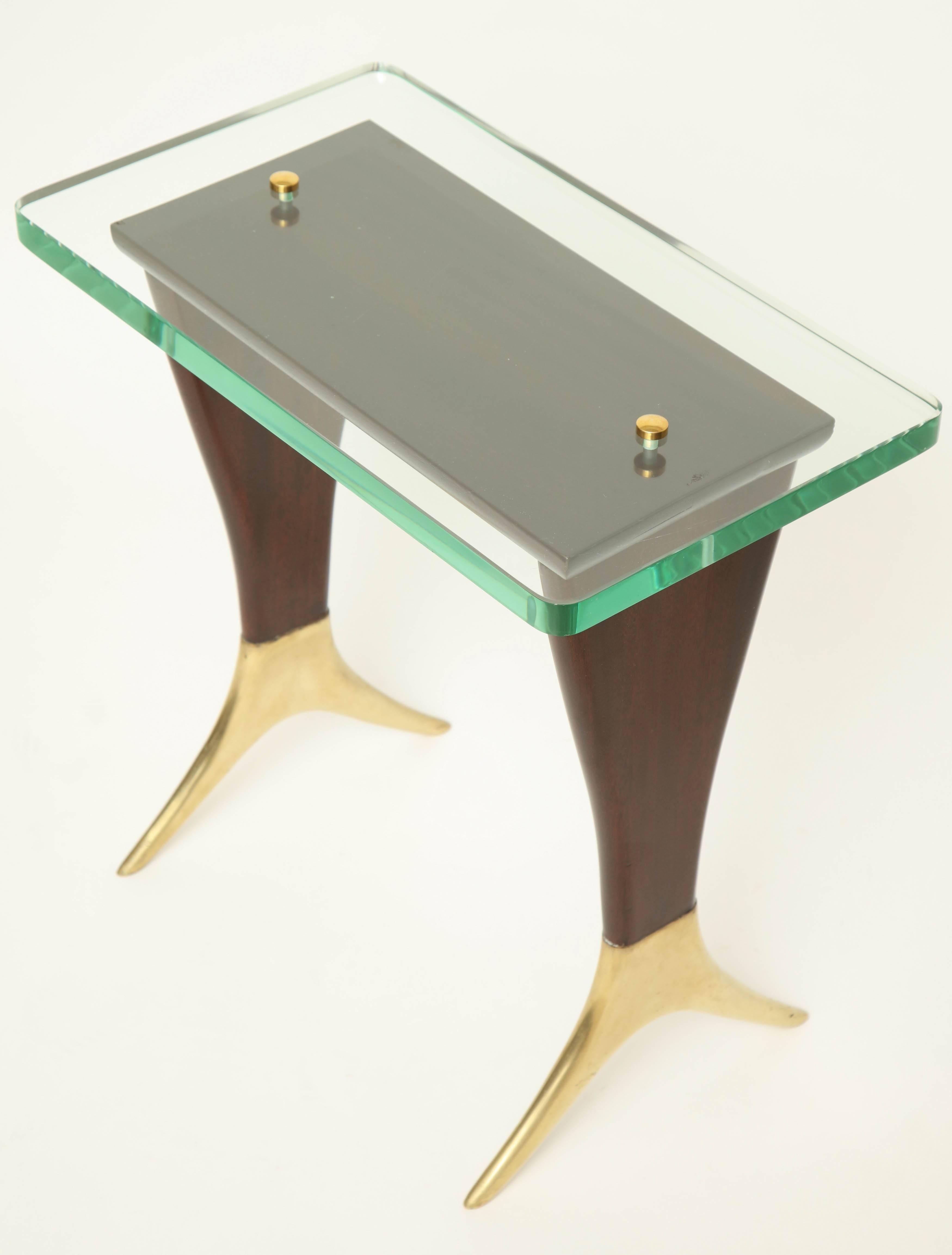 A small, rectangular wood and brass side or cocktail table with brass splayed feet and glass top. Designed by Cesare Lacca, circa 1950, Italy.