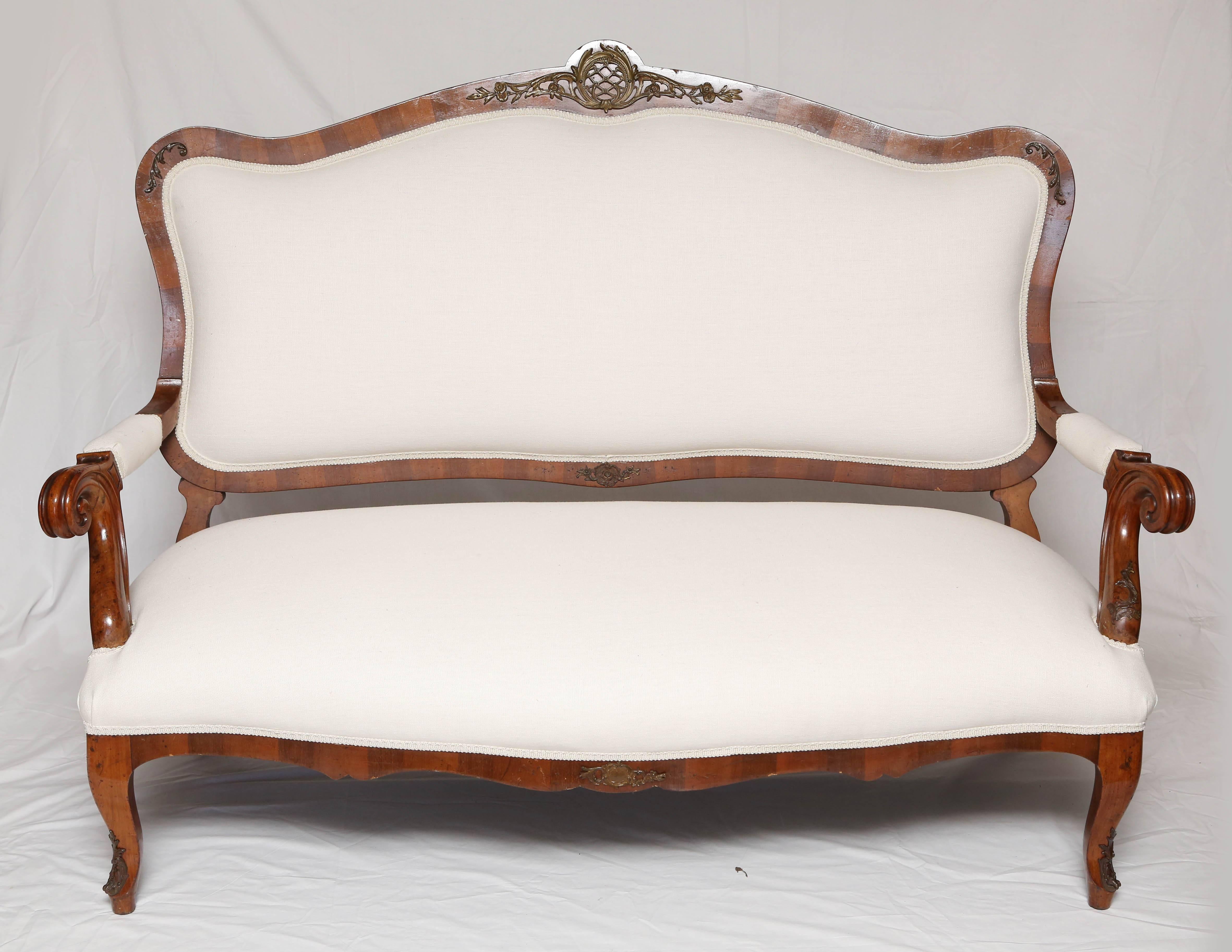 This is a superb walnut French loveseat or settee with white upholstery gilt metal accents, it has some nice brass work to the legs and back, in a white fabric.
The condition is good, made in France, circa 1860.
The fabric has been recovered this