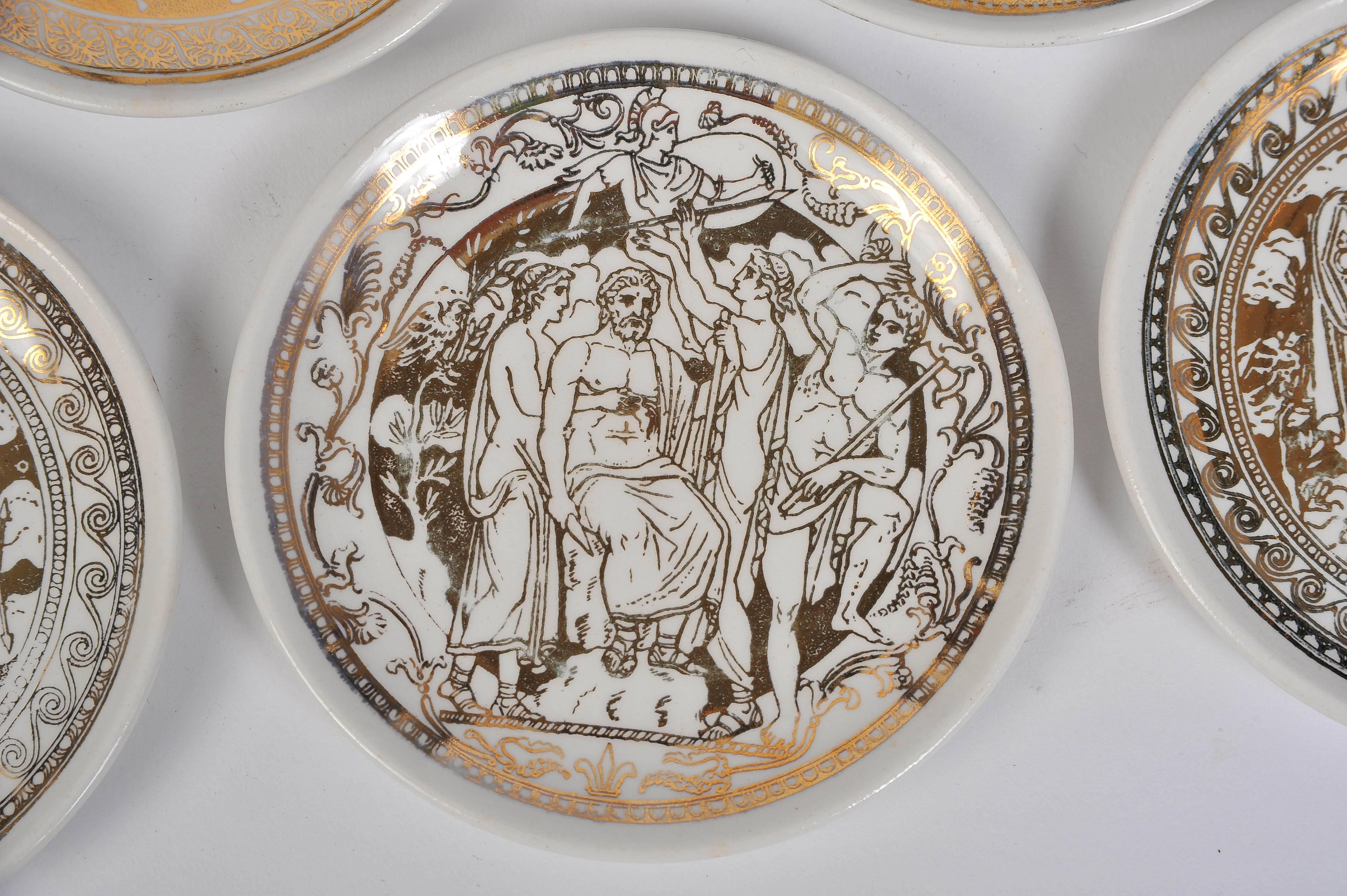 Set of seven small plates with their original box by Piero Fornasetti.