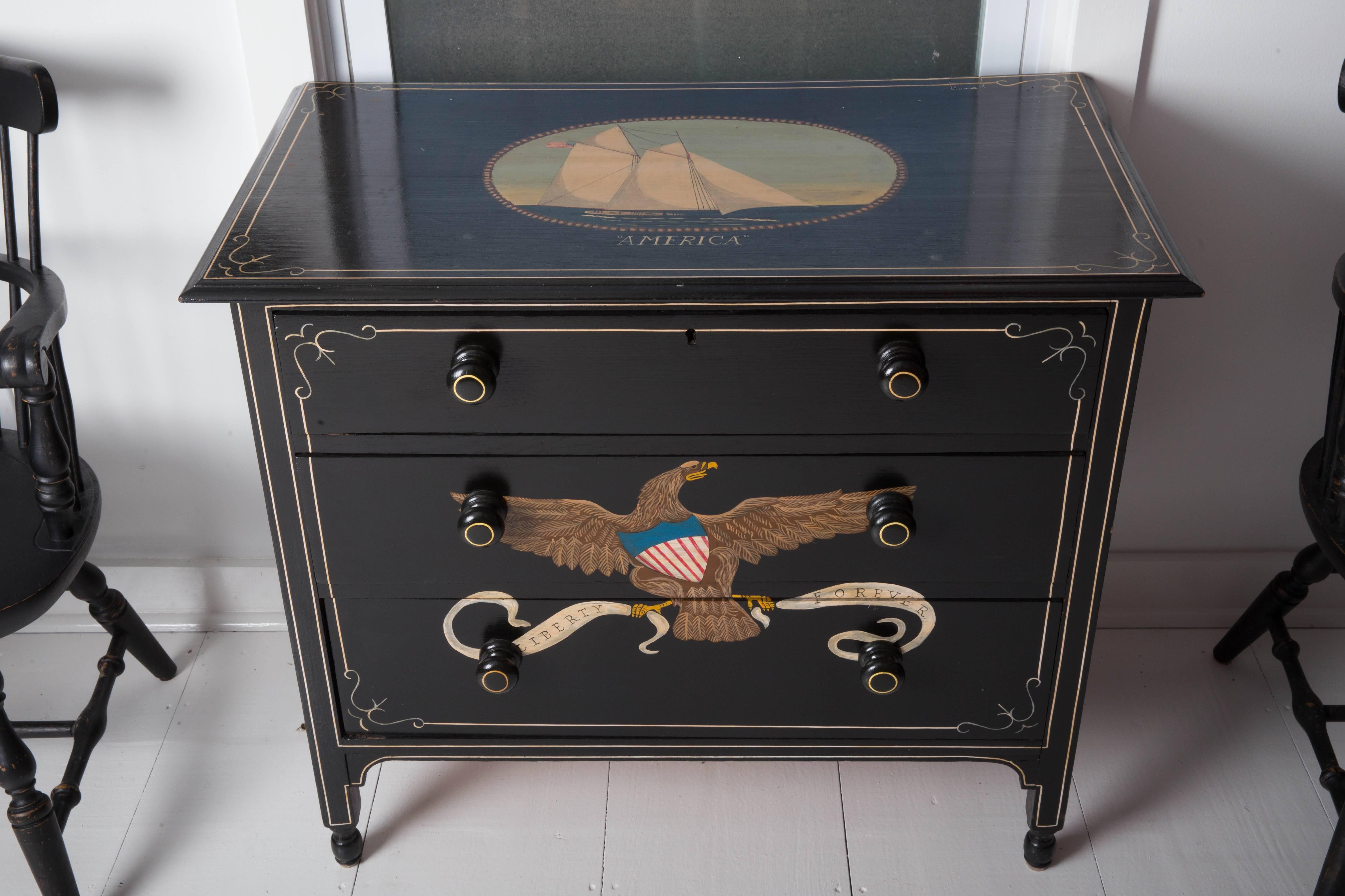 Hand-painted nautical/eagle decorated chest of drawers. Black with nautical painted decorations of a sailing Ship 'America' on the top and colorful eagle and anchors on the front and sides. The chest consists of a three drawers, circa 1950.