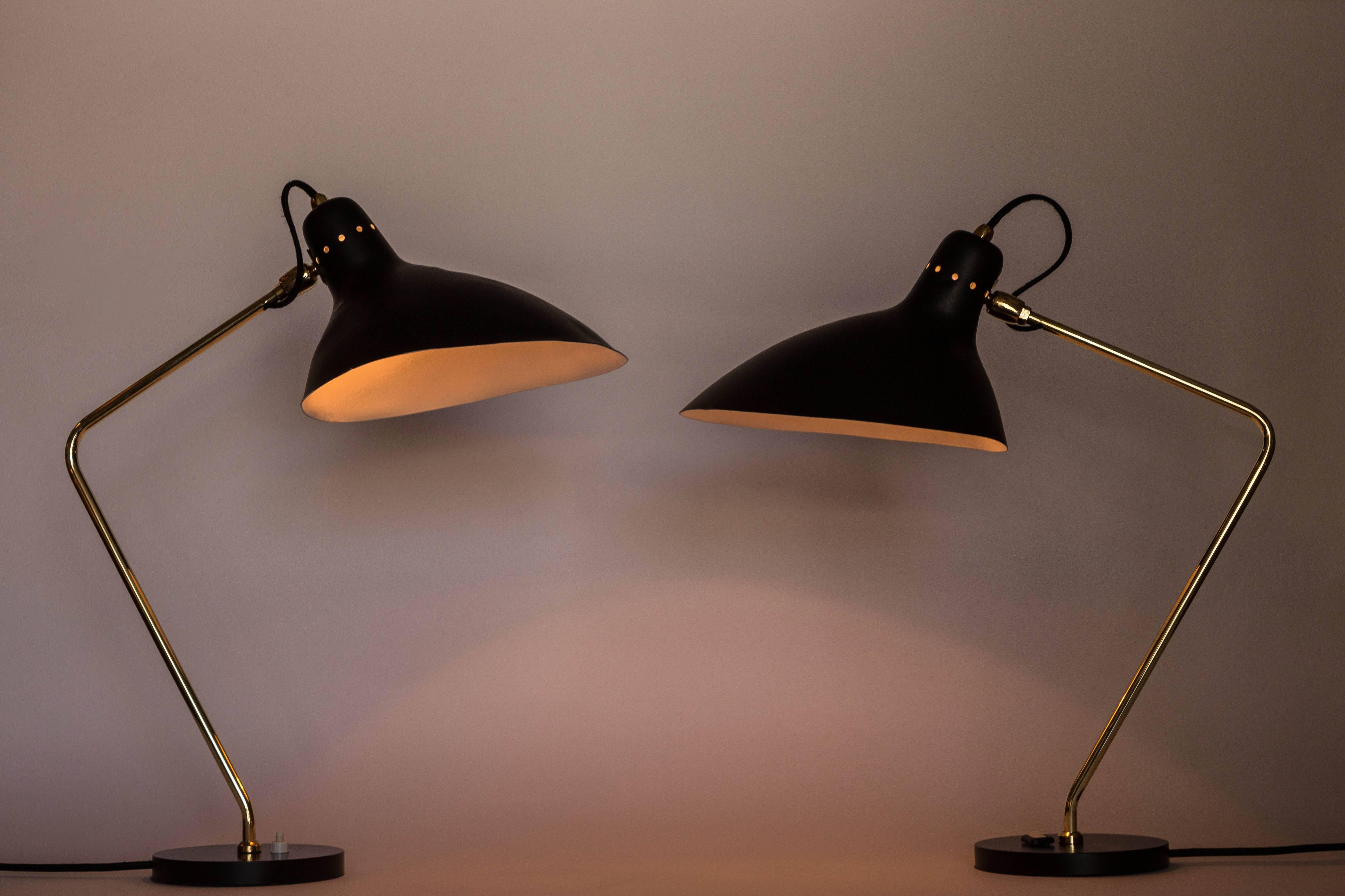 Pair of 1950s Boris Lacroix table lamps. These rare and elegant table lamps are executed in black metal and brass, France, circa 1950s. A celebrated Art Deco lighting designer who successfully made the transition to Mid-Century Modern idiom, Jean