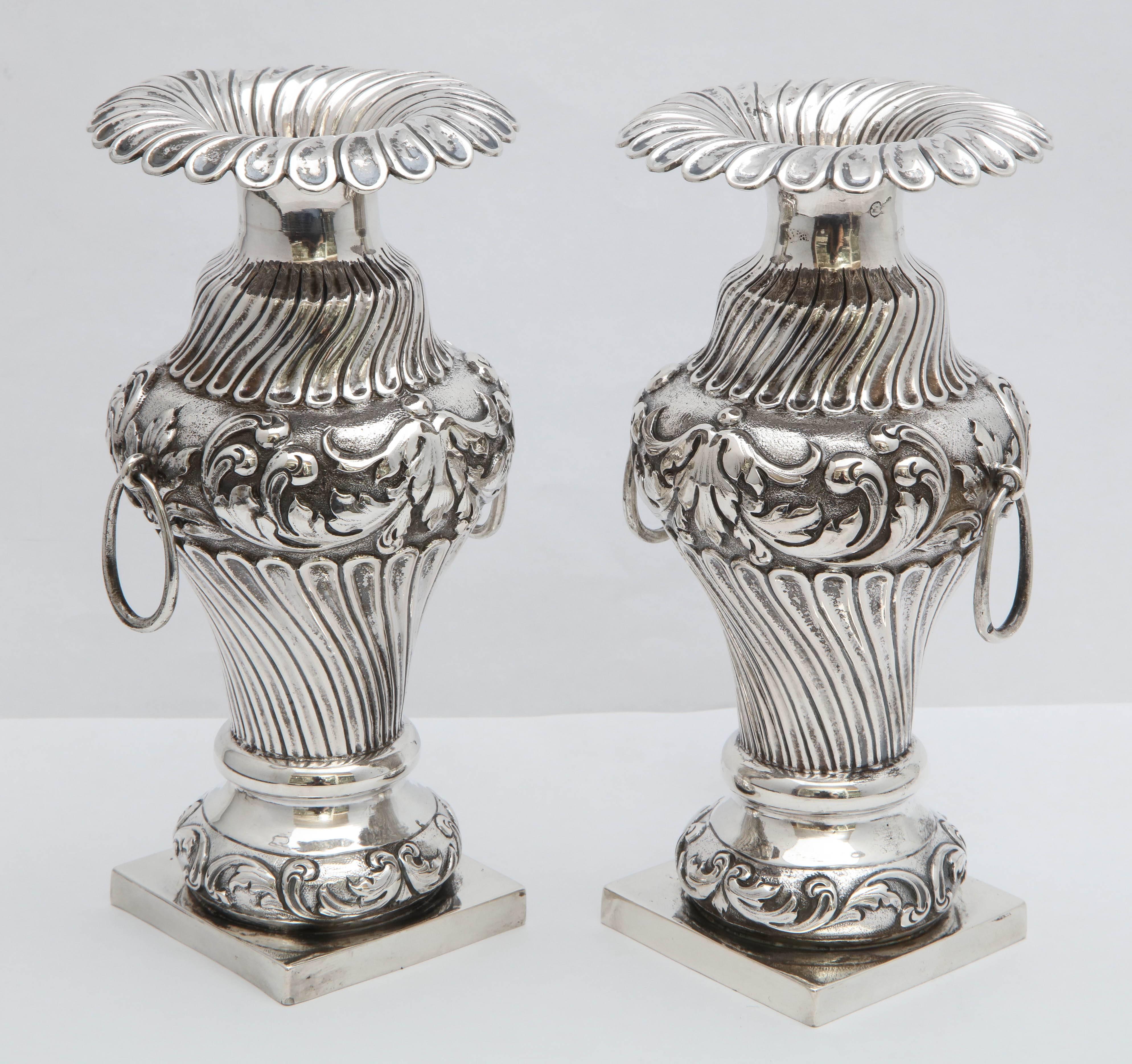 Beautiful pair of Continental silver (.800), Dutch, Victorian vases, year hallmarked for 1896. Lovely form, each having a square base and fluted, swirled opening and design. Each is 6 3/4 inches high x 3 3/4 inches diameter across widest point x 2