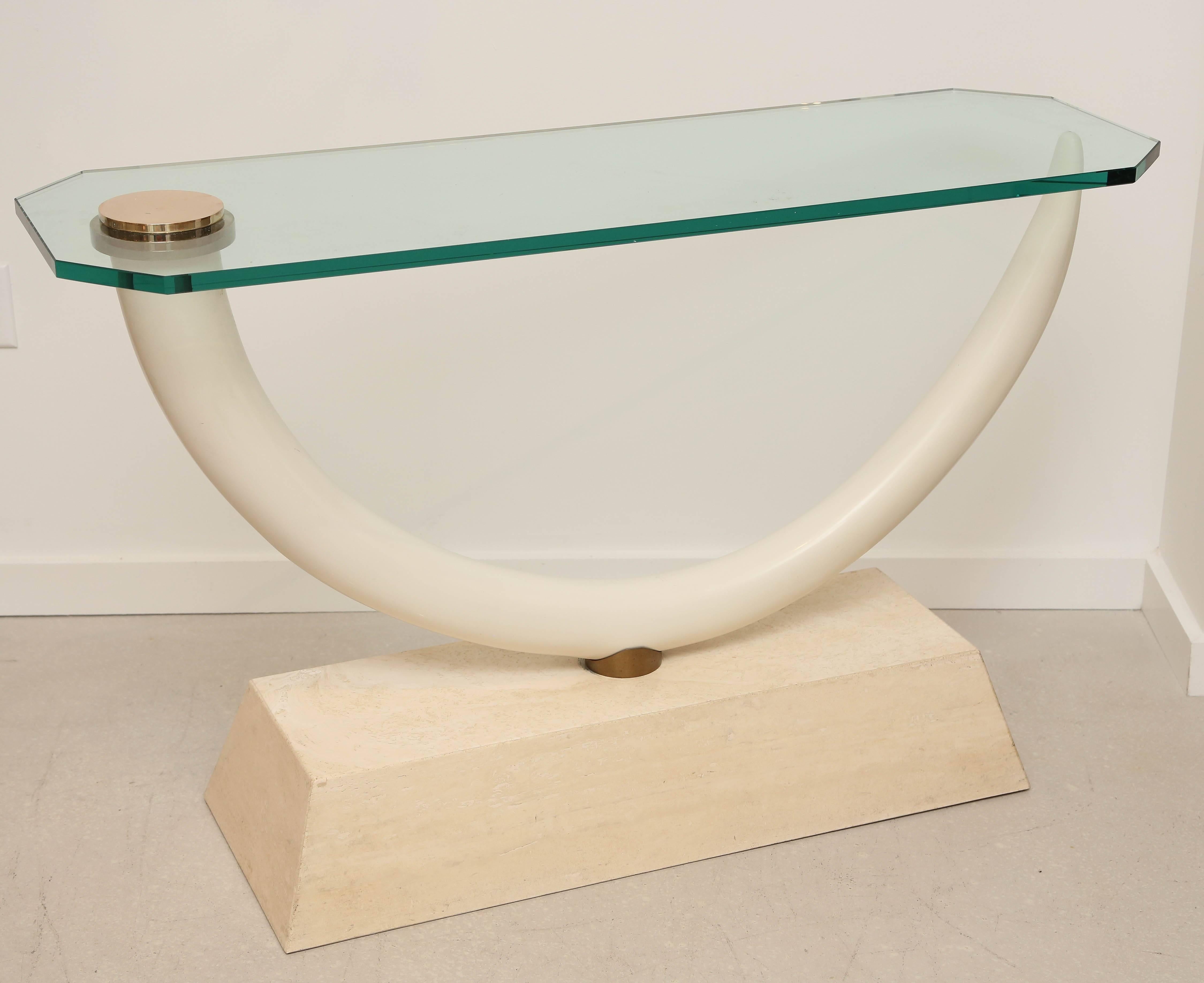Mid-Century console table with faux tusk as support and glass top.