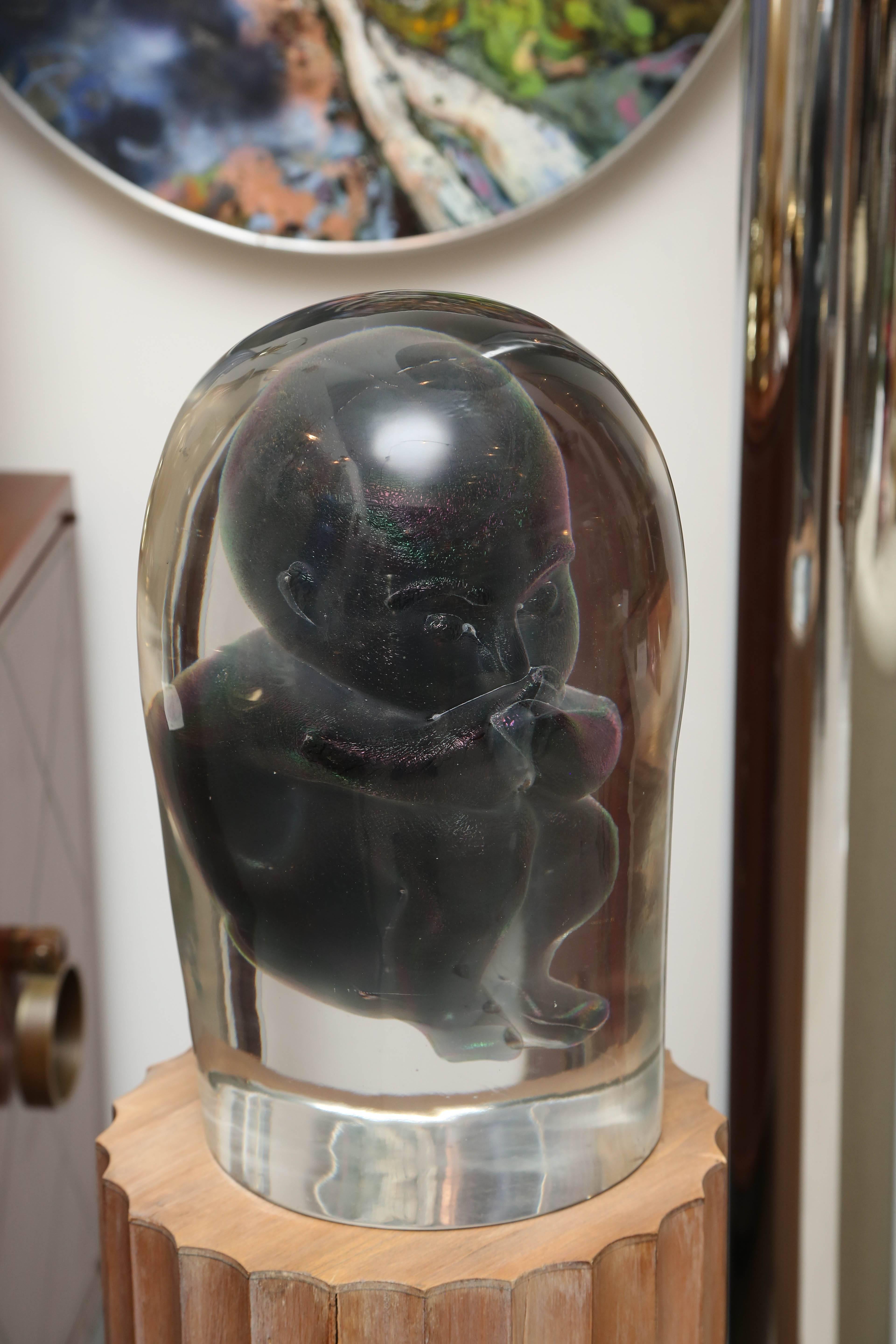 Truly strange objet de vertu made of Murano glass made by Elio Raffaelli. The fetus is truly iridescent deep blue in person-- but photographed very dark. The sculpture is extremely heavy (110lbs) and intriguing from all angles. It is sold with the