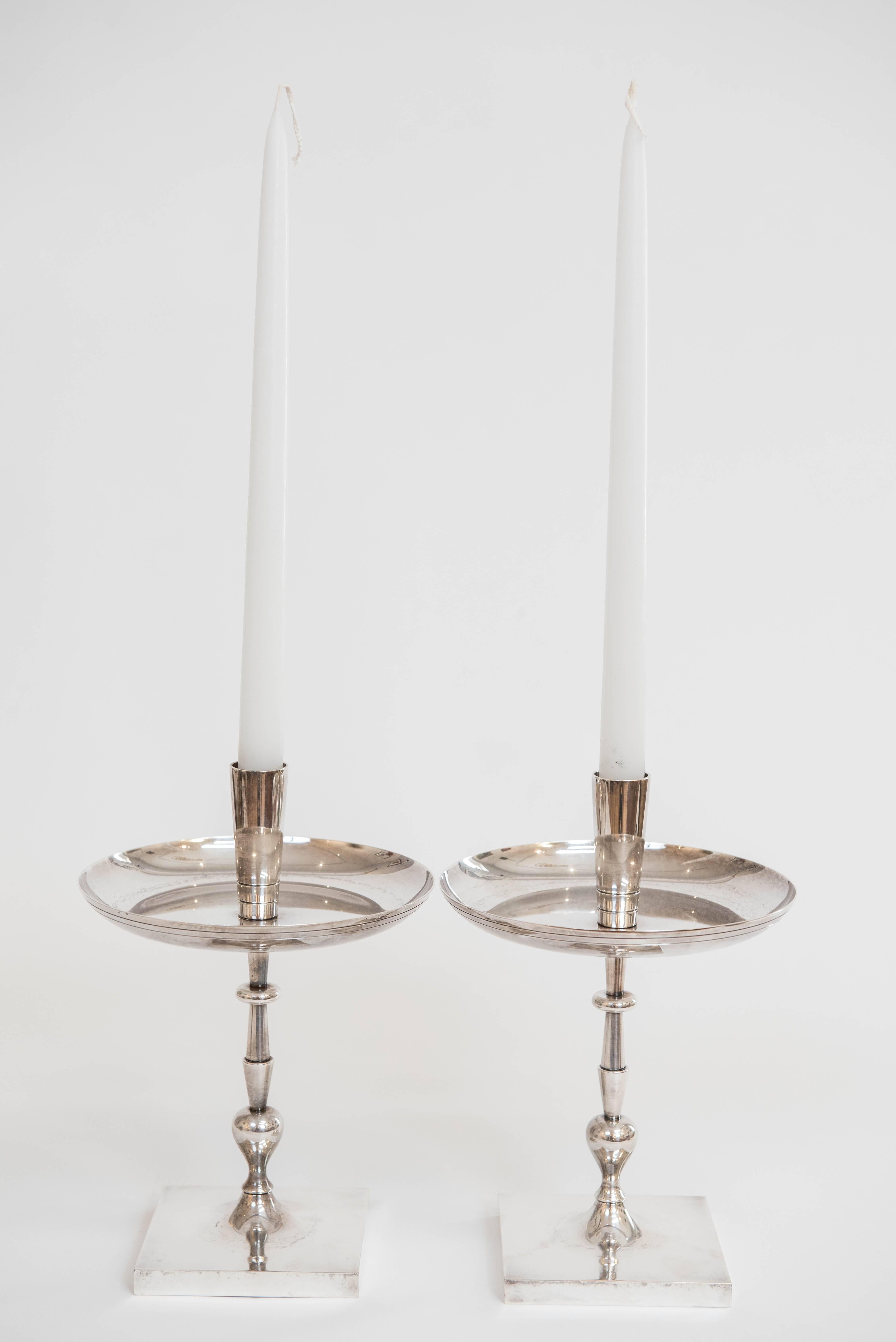 Add style and sophistication to your table with this impressive pair of single candle holders designed by Tommi Parzinger. Stamped HEIRLOOM 
