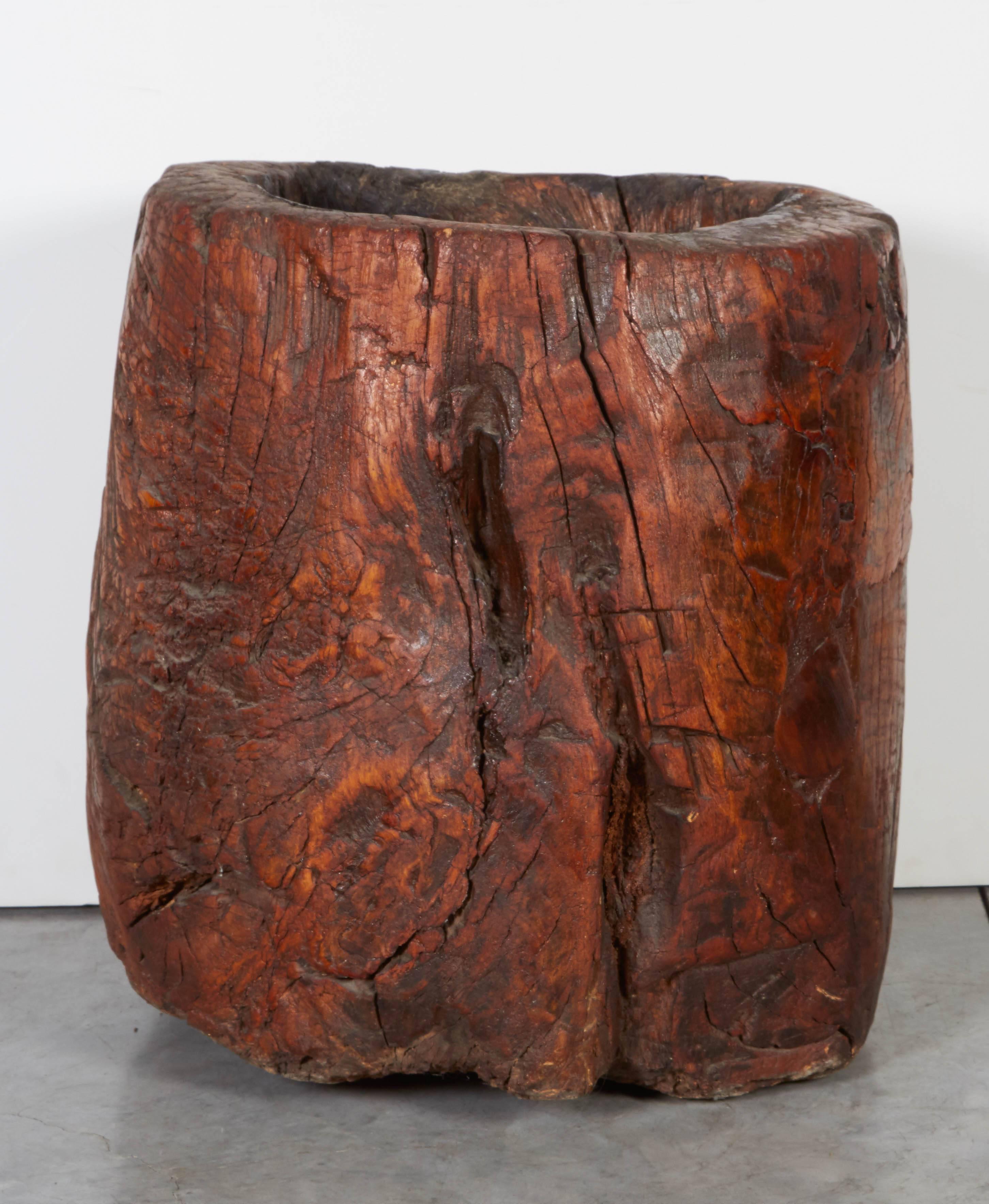A tall and heavy antique Chinese mortar carved out of a single piece of burl wood with thick walls, great patina, and tremendous presence. Burl wood mortars of this size, age and condition are a real find. 
M581g.