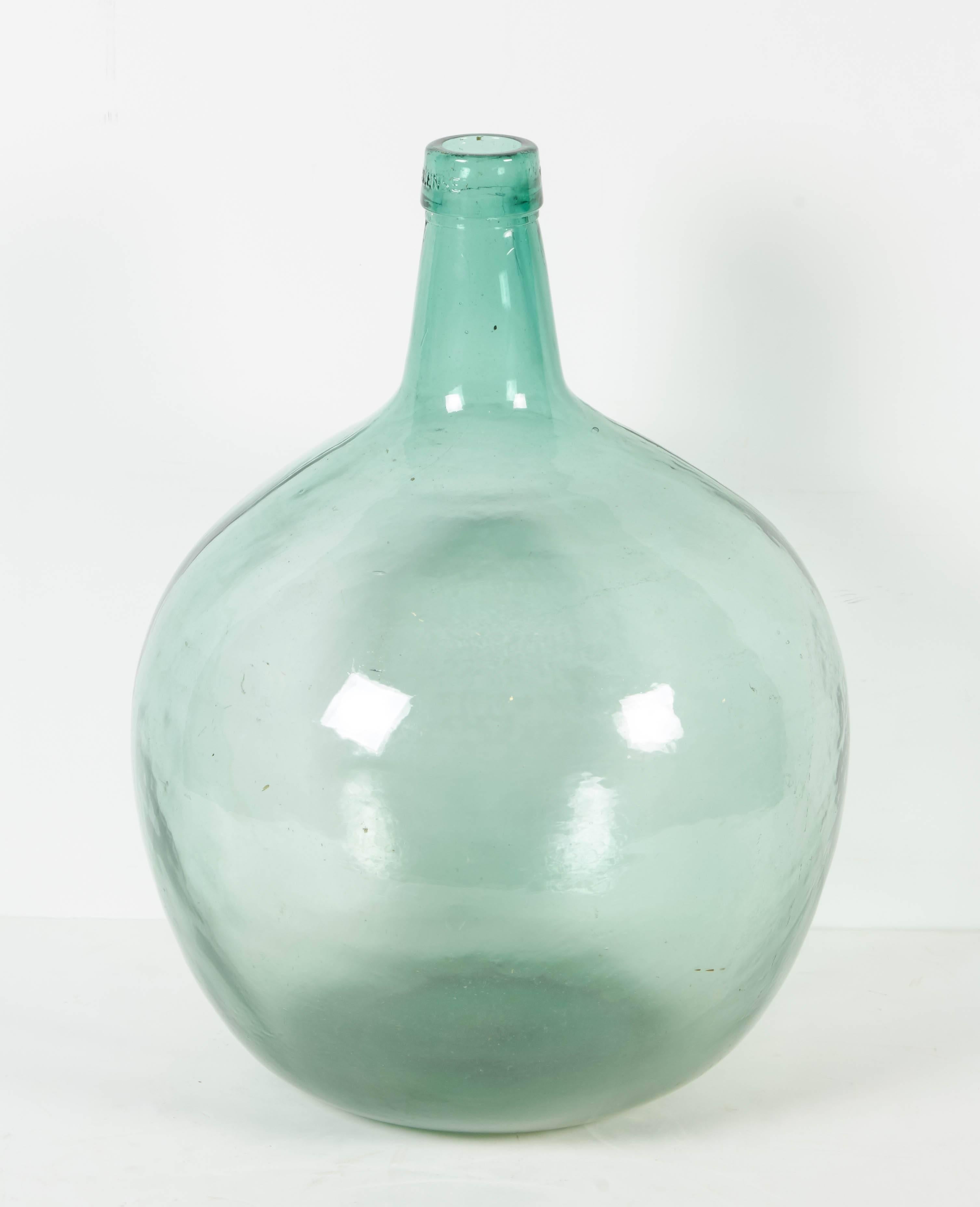 A graceful antique blown glass French demijohn with fabulous light greenish hue.
 