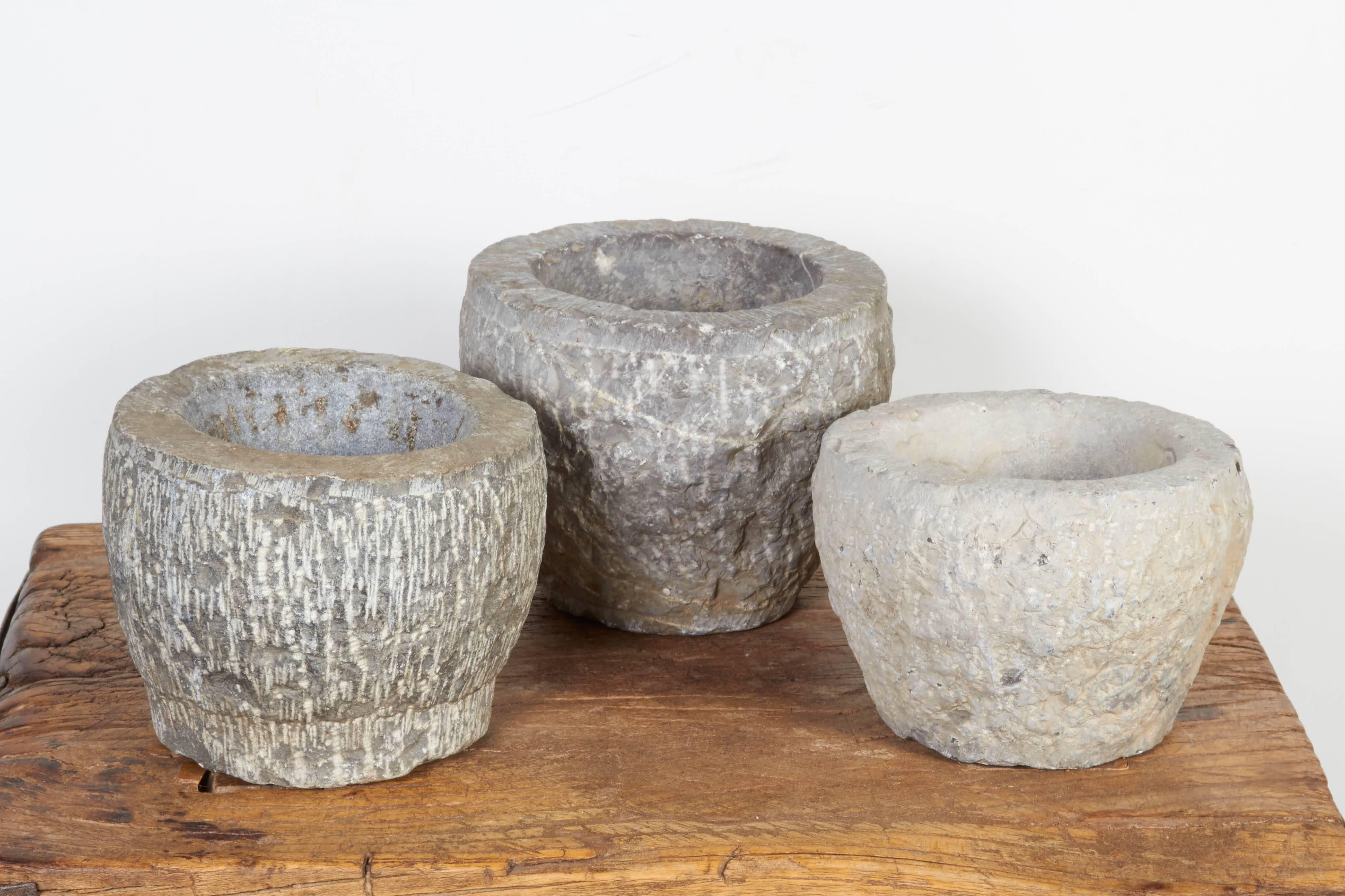 Three gracefully shaped, light colored solid stone mortars from Shanxi Province, China. These nicely textured pieces are suitable for many uses and work perfectly as shelf decoration. Priced individually.
M819b.
