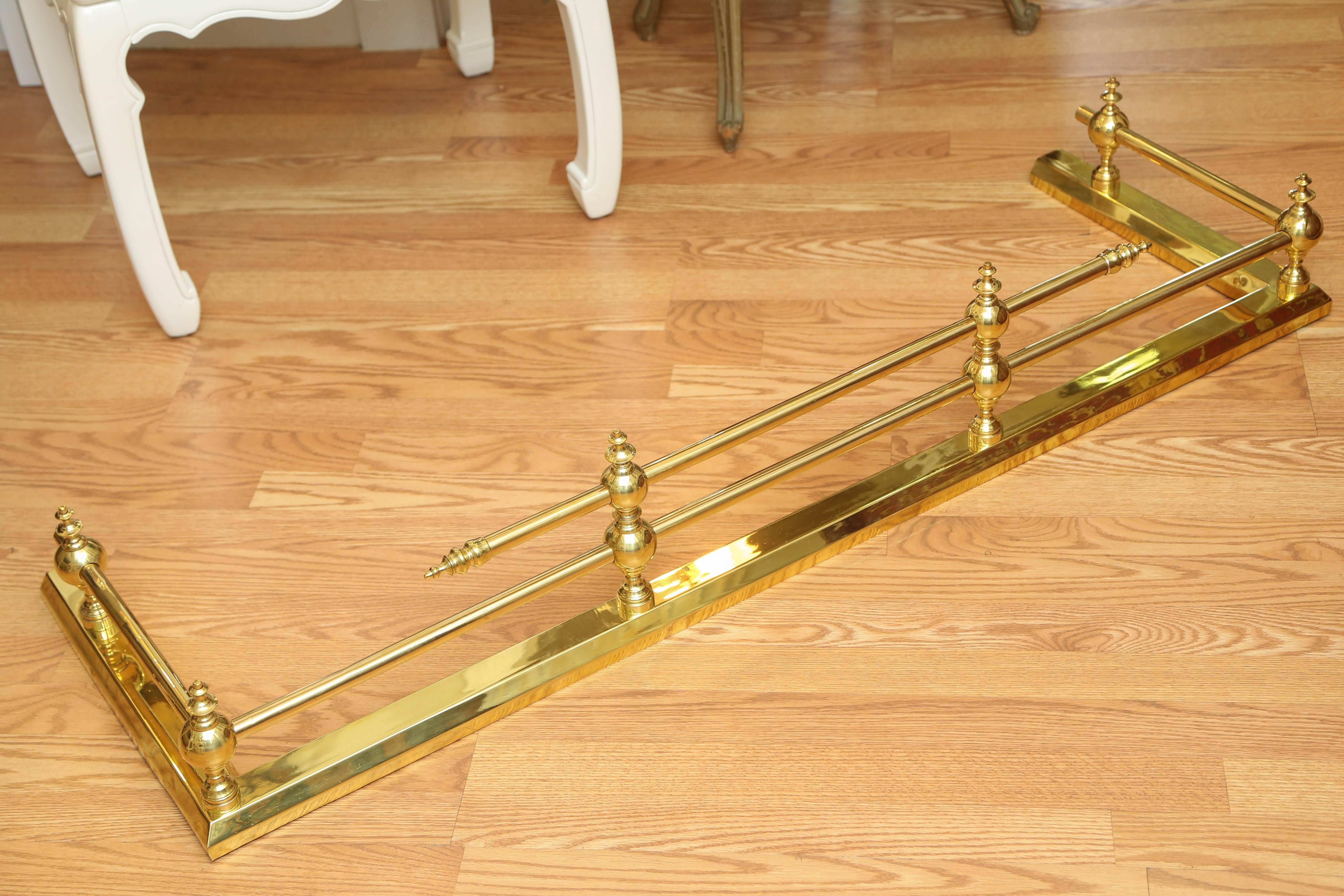 Classical style brass fireplace fender.