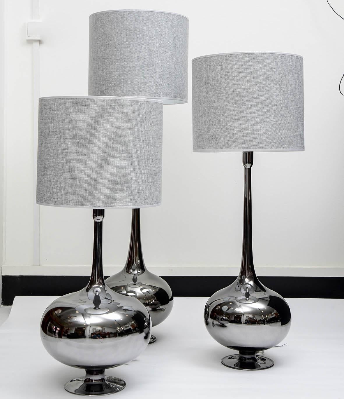 Set of table lamps in glass. Titanium finishing.
Three different sizes: 69 cm, 82 cm, 98 cm

 