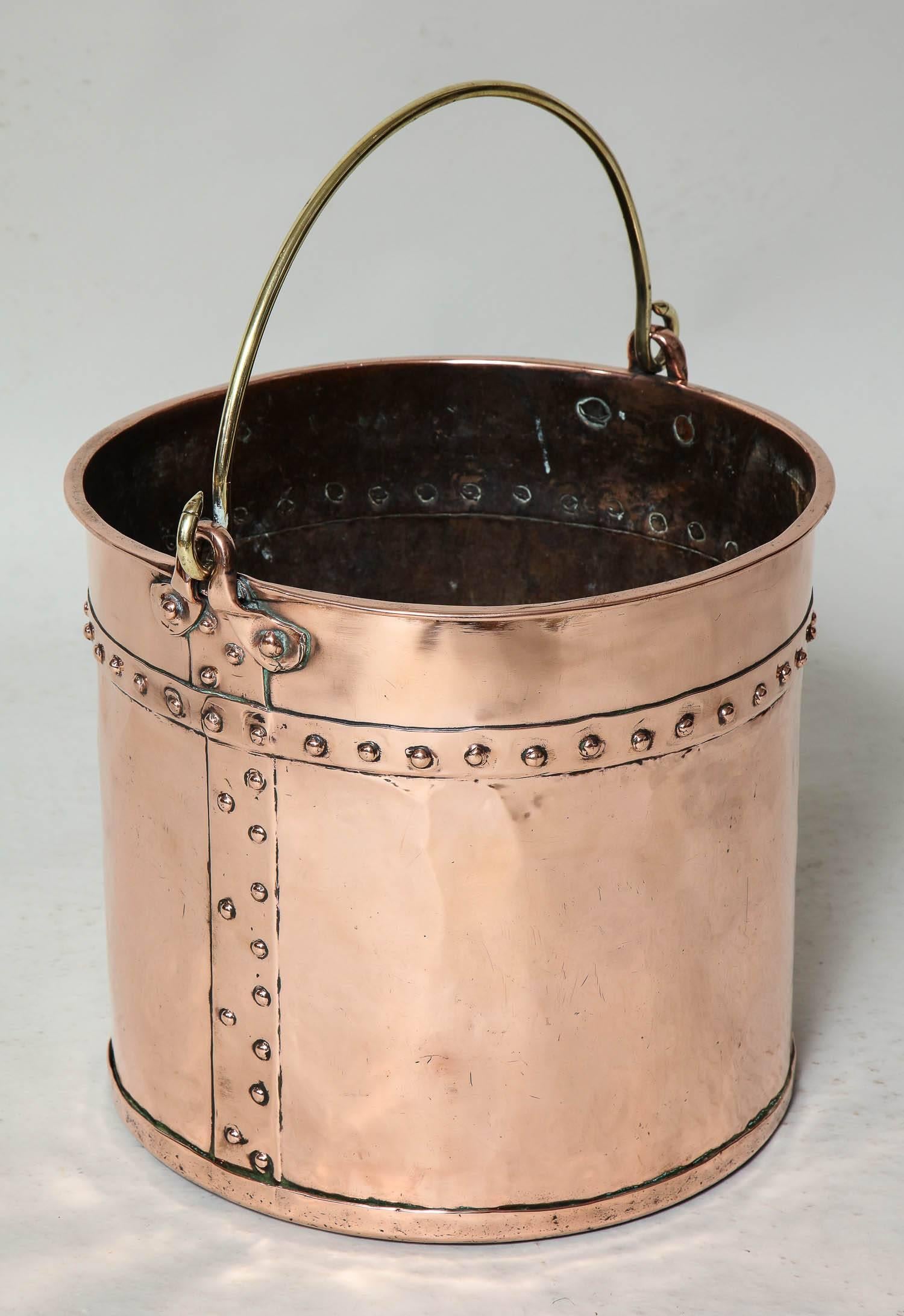 Good English 19th century copper bucket with brass bail handle, rolled edge and hand-hammered riveted construction. Excellent for kindling or waste paper basket.