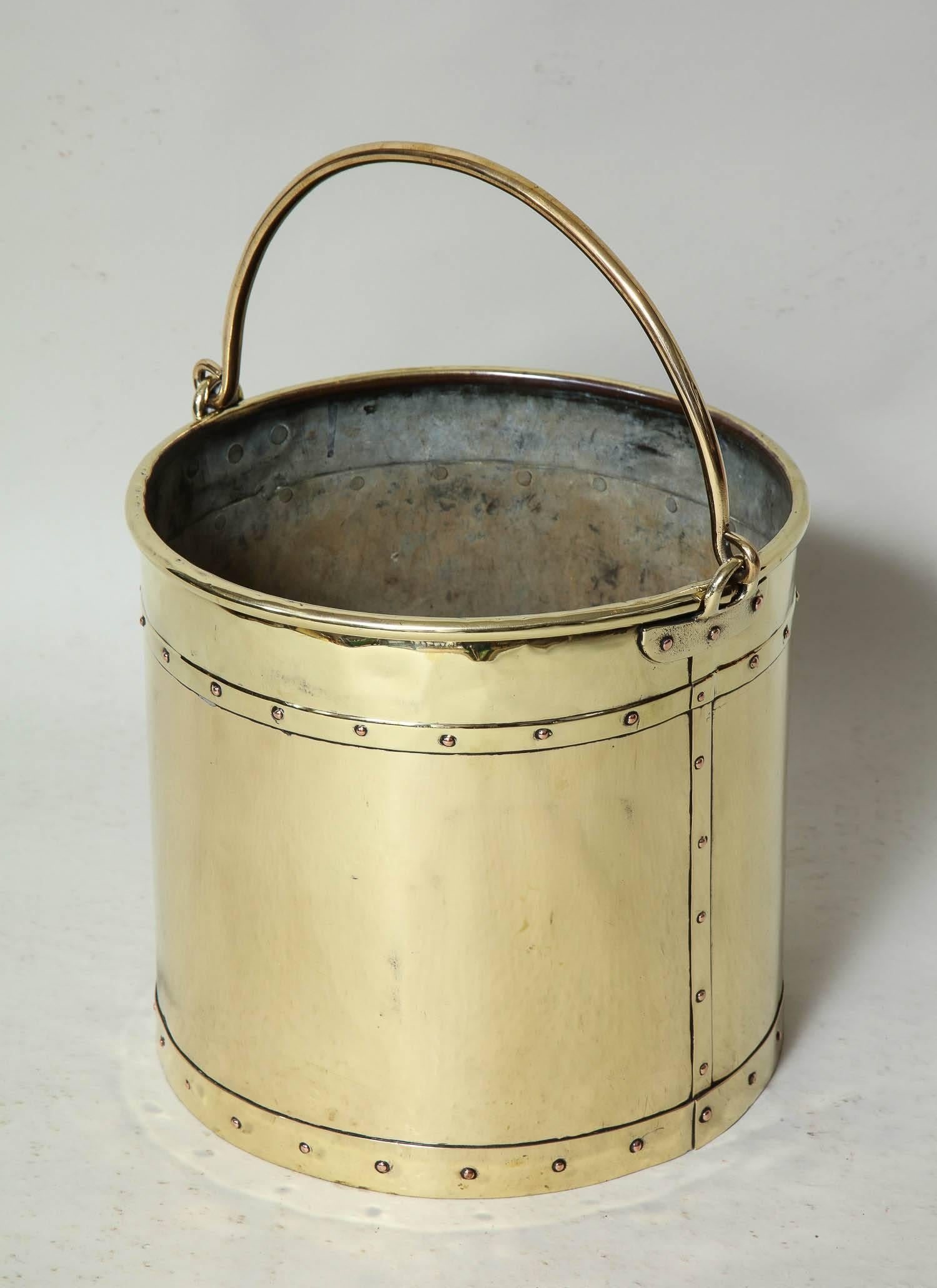 Good English 19th Century brass bucket with brass bail handle, rolled edge and hand-hammered riveted construction. Excellent for kindling or waste paper basket.