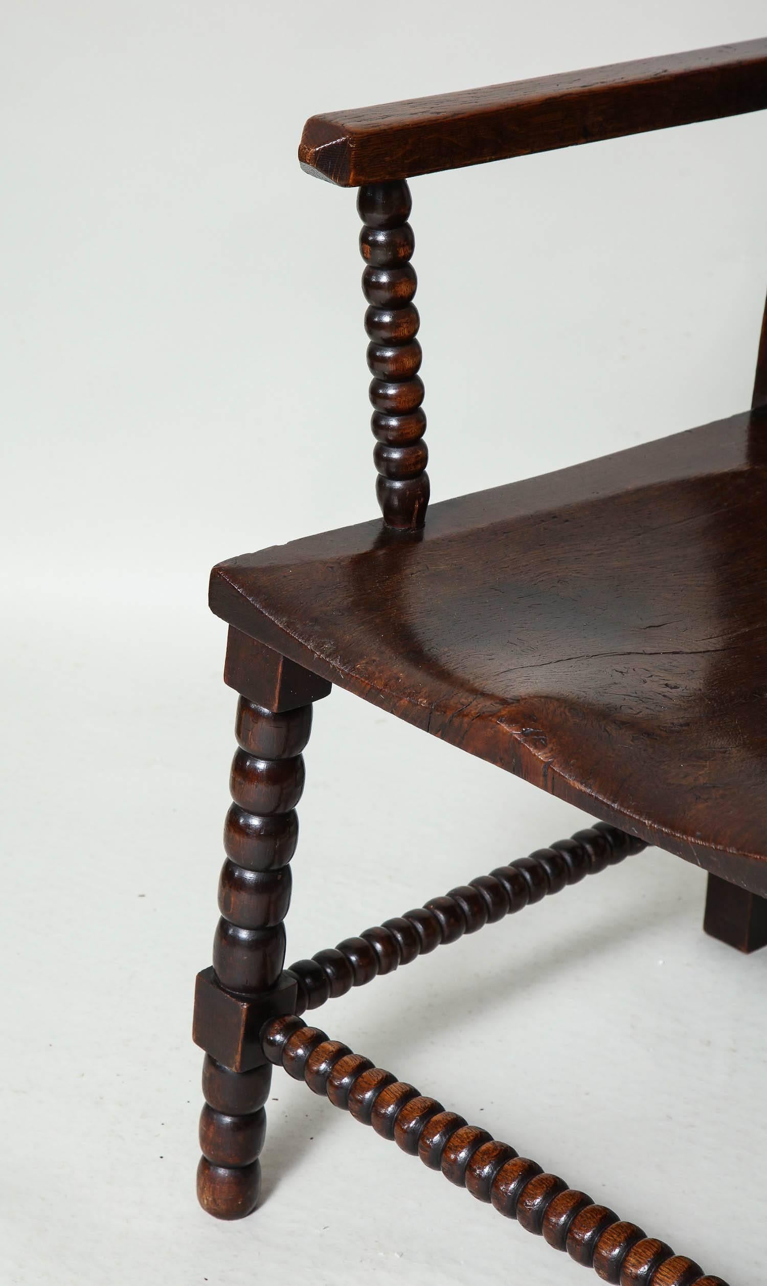 Fine English mid-19th century oar armchair with bobbin turnings, the rails with pyramid finials over open back with arched slats and bobbin spindles, the square arms with bobbin turned supports over shaped saddled seat having block and bobbin turned