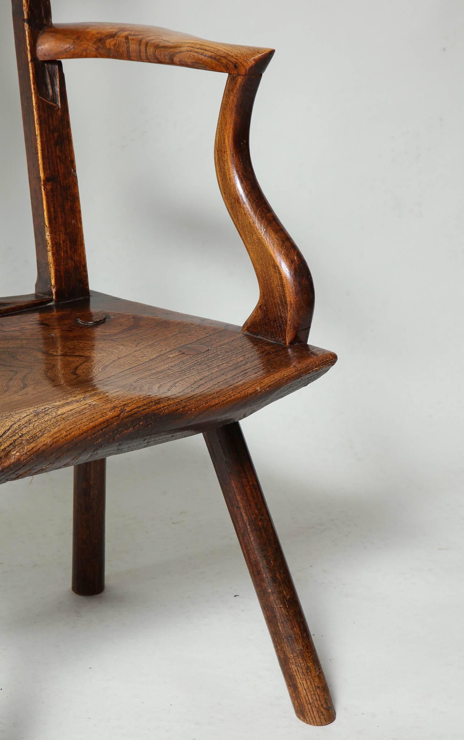 A rare early 18th century Welsh Silhouette chair having sinuously shaped back arms and seat with great color. A very good example of vernacular design and workmanship, and a wonderful addition of personality to any room.