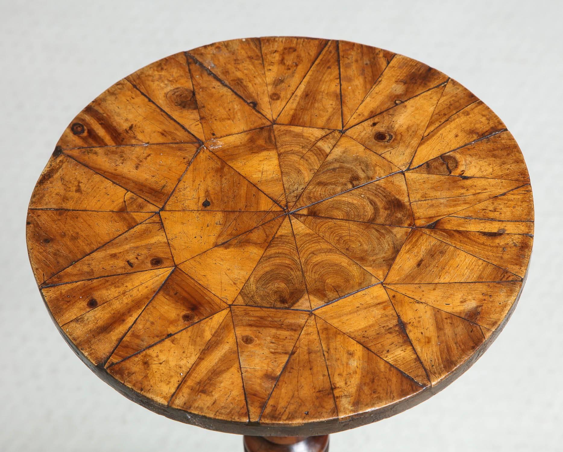 Rare English late 17th century turner's or thrown table, with yew wood parquetry top over boldly turned shaft, the four similarly turned splayed legs joined to ring turned platform, the whole possessing great color and patination and of very graphic
