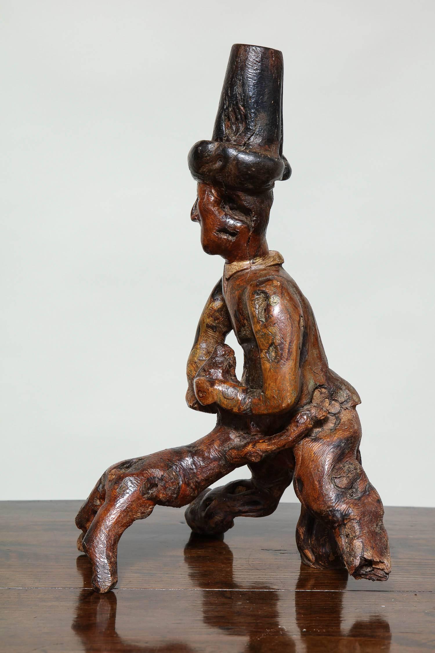 Wonderful English 19th century Folk Art sculpture of a man being greeted by his dog, the figure wearing a tall Cornish hat hugging and being hugged by his adoring four legged friend, the whole carved from a single root and with original polychrome