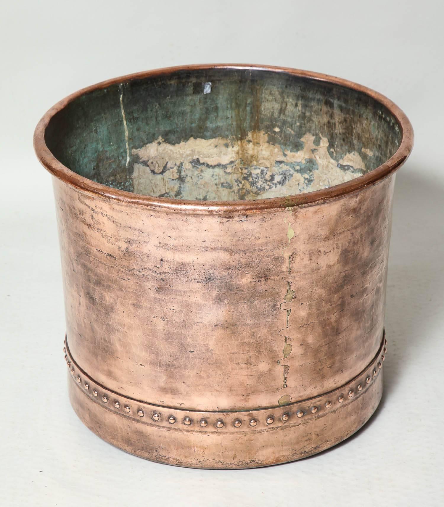 Very fine 19th century English copper log bin, having rolled edge over finely beaten and slightly tapering sides, dovetail joined seam and hand riveted banding. Ideal for firewood or as planter.