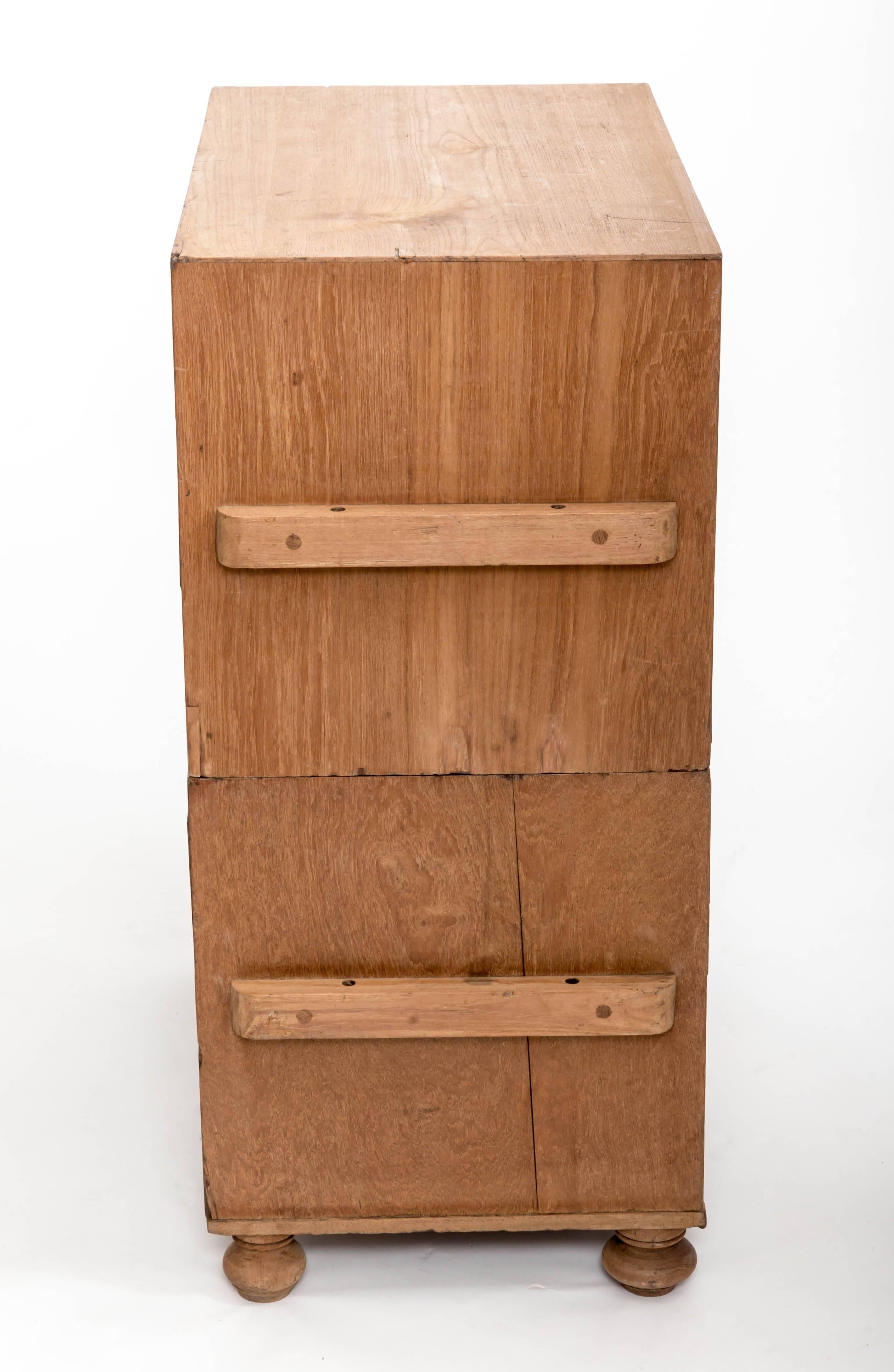 Naval officers military chest with two short drawers over one long, with recessed military handles and turned bun feet, two pieces.