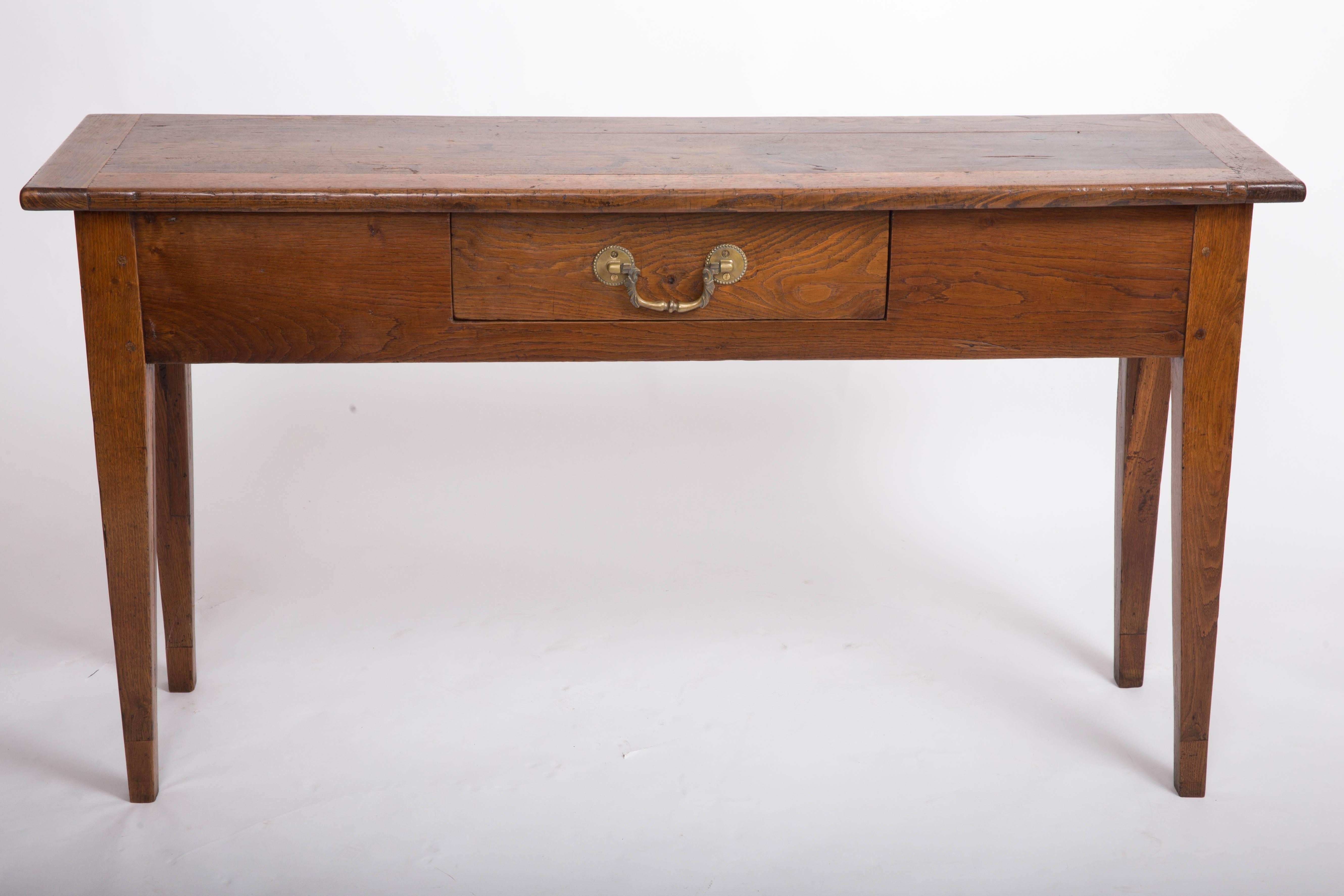 Unusual narrow oak server, top boarded with chestnut, one drawer with original iron pull, tapered legs.