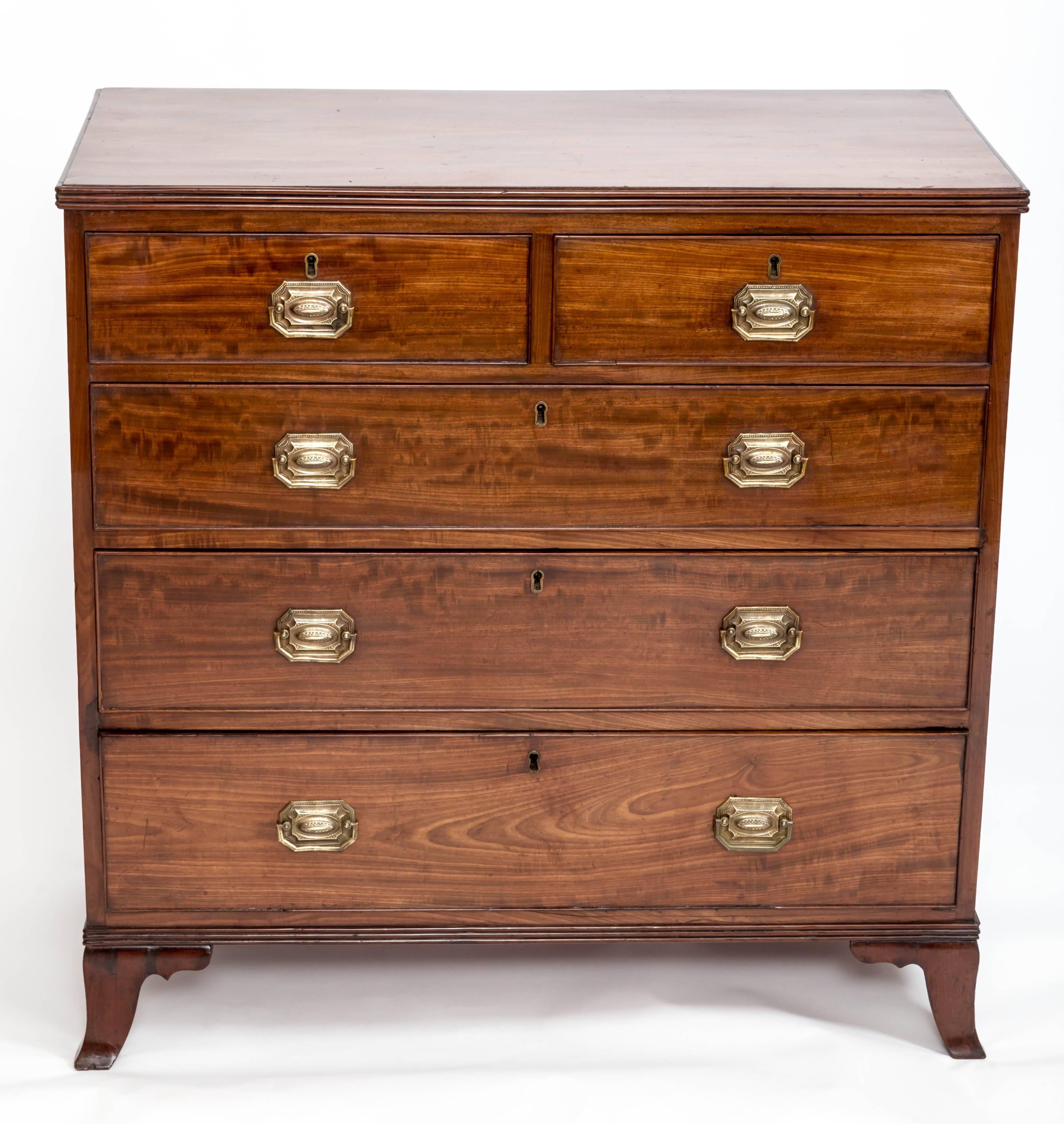 A handsome five-drawer mahogany chest (two short, over three long), reeded top, sprayed legs, original brass pulls.