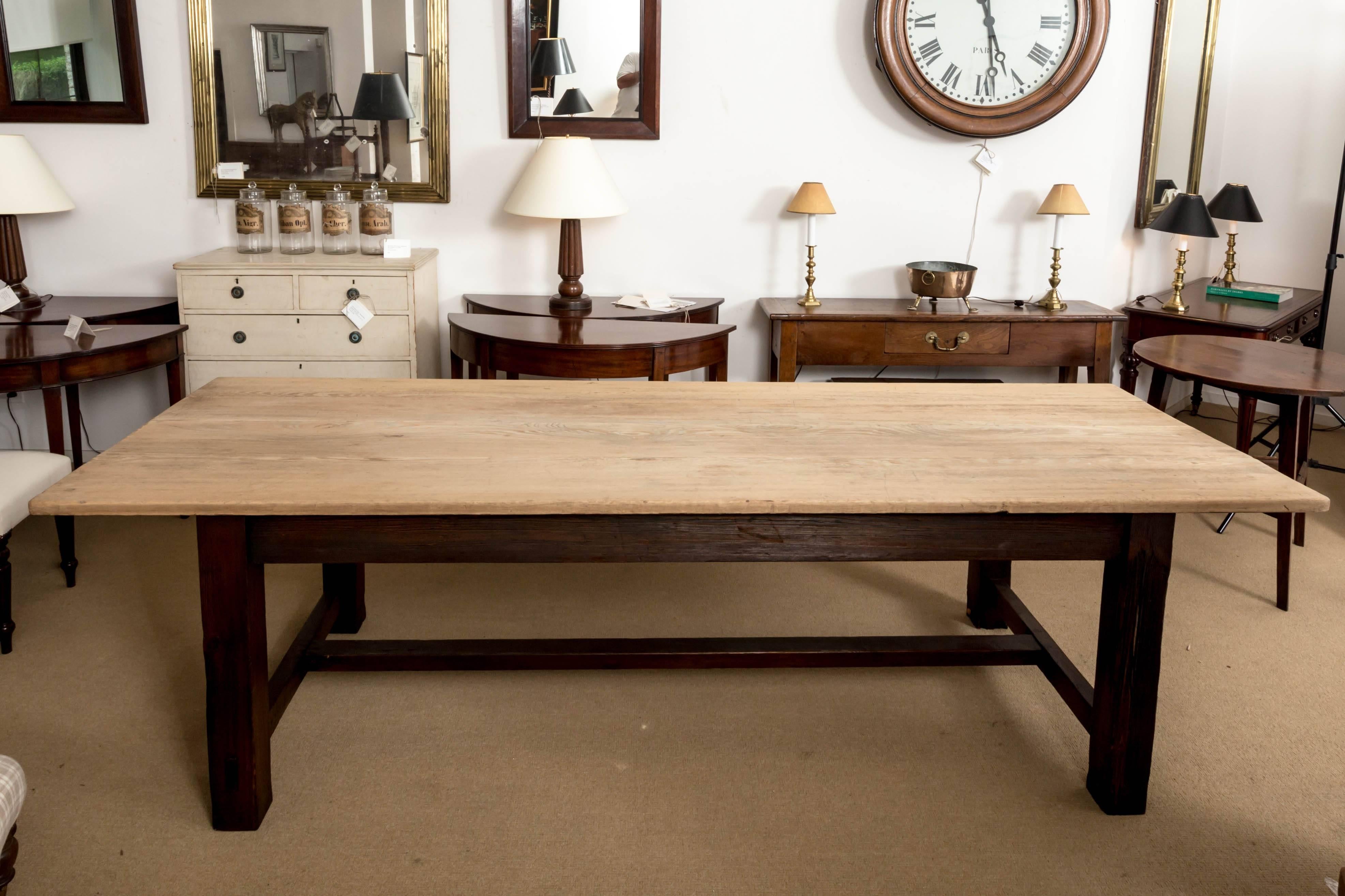 Long farmhouse 9 foot dining table with original scrubbed pine top and original stained pine base with original stretcher. Seats 10-12.