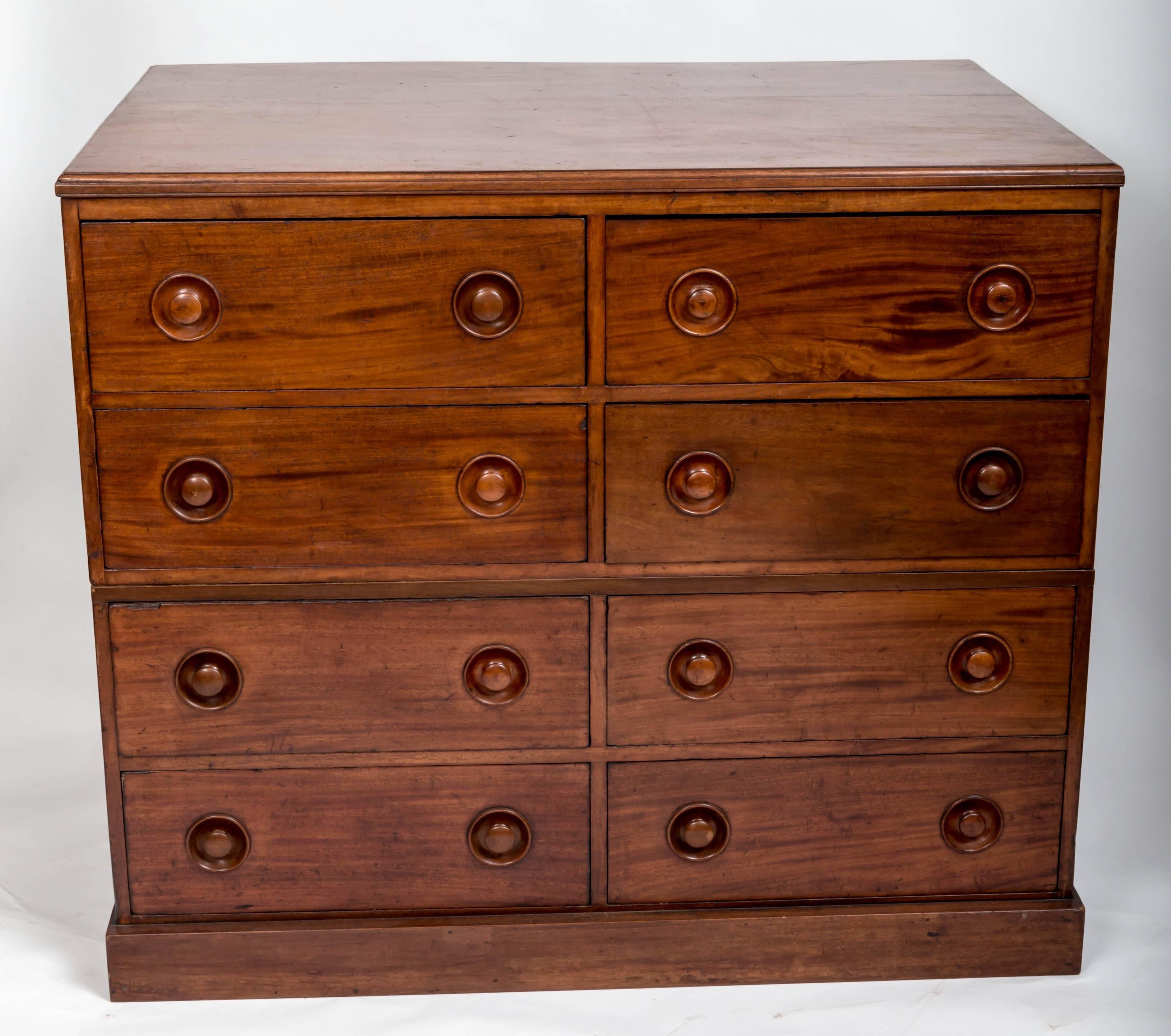 Unusually deep chest, originally used as a milliners cabaret, eight deep drawers on a plinth base. In two sections.