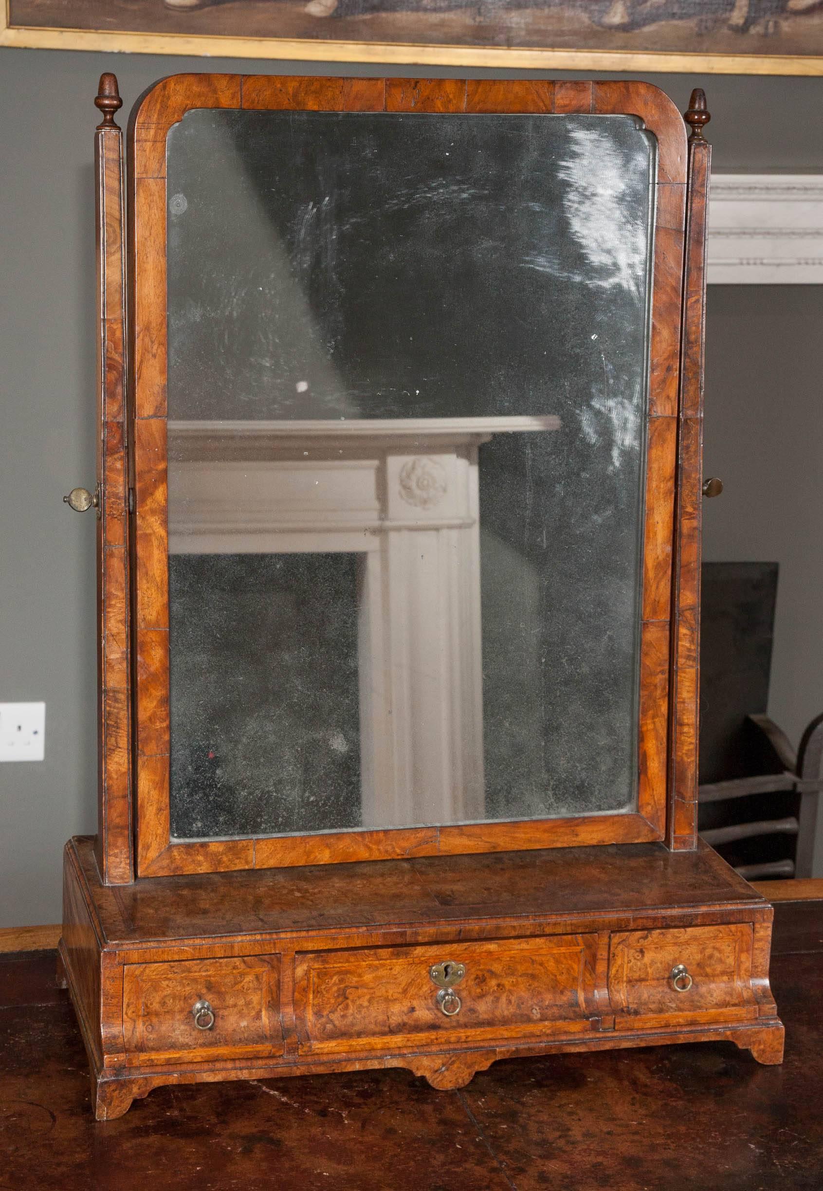 A George I burr and figured walnut dressing mirror with original plate, circa 1710.