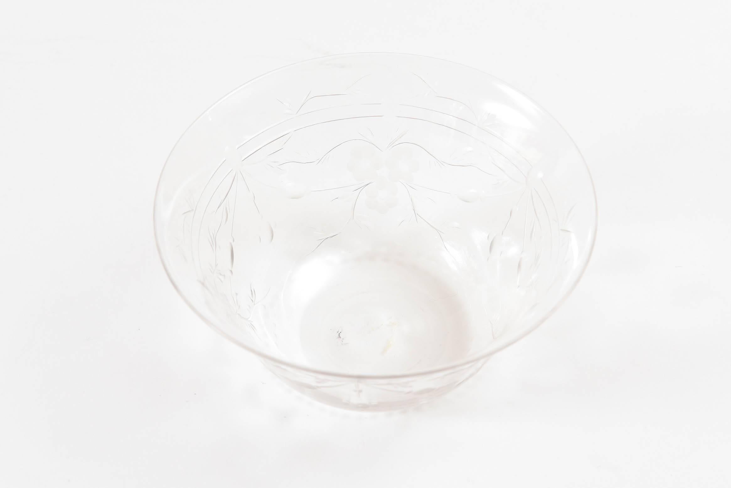 A suite of 8 blown crystal bowls featuring an elaborate all-over engraved floral design. A great size for ice cream, fruits or puddings. We attribute them to one of the fine English glass firms and in very nice antique condition.