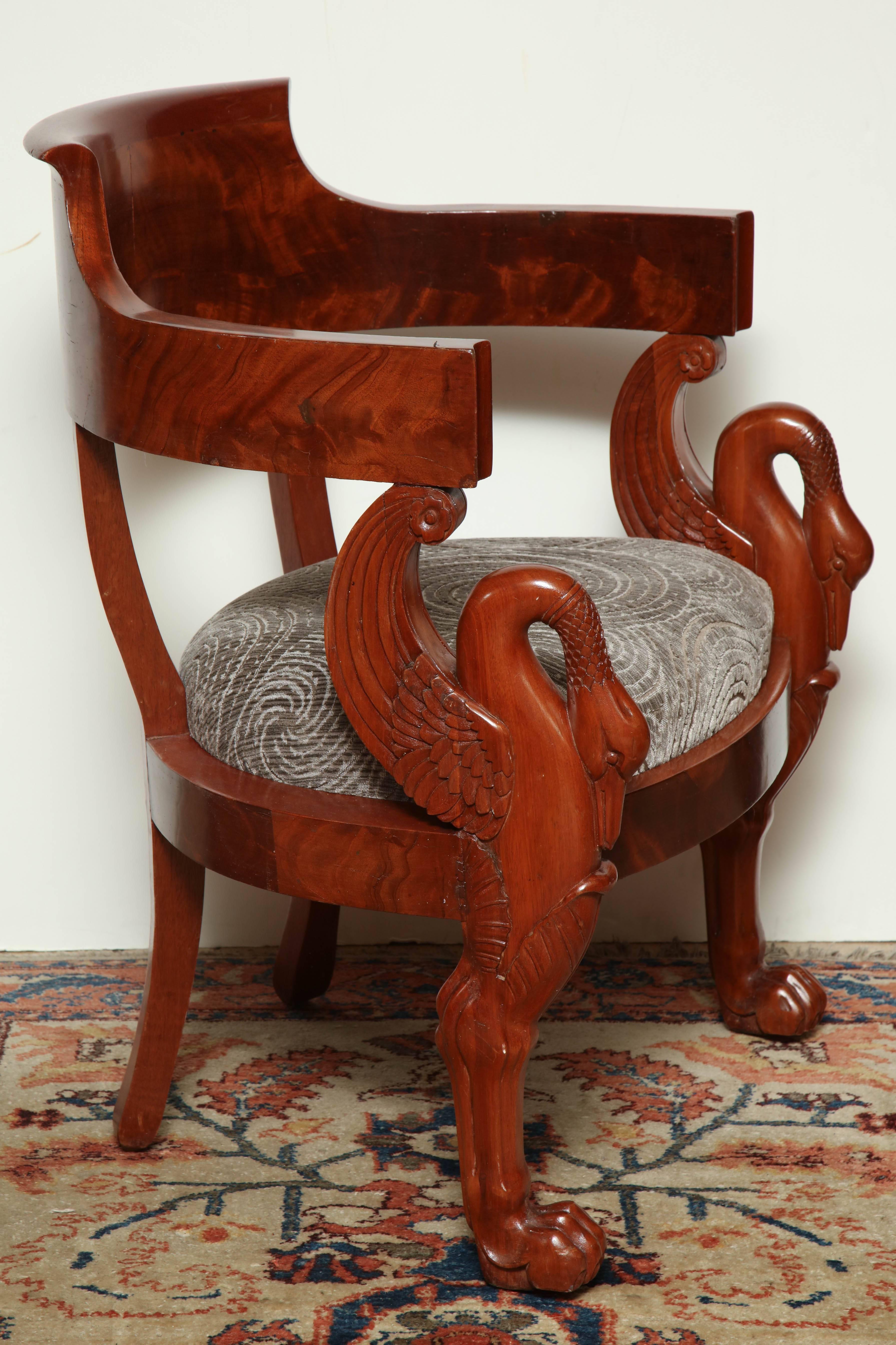 French Directoire mahogany carved armchair with swans and carved paw feet.