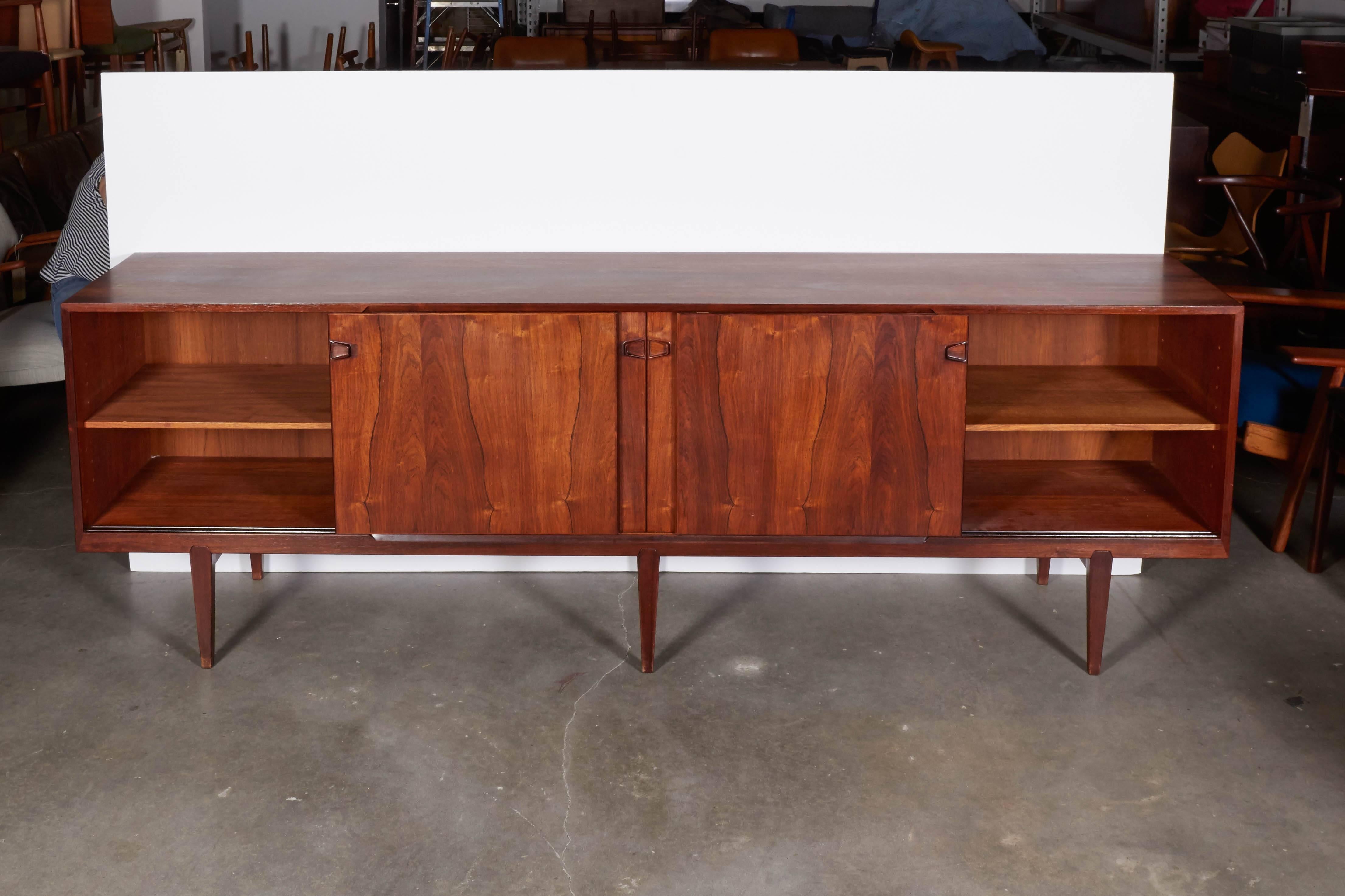 Vintage 1960s Rosengren Hansen Credenza

This extra long sideboar is a finely made 8ft long rosewood sideboard with 6 legs. Can be used in the living room for media storage, the bedroom for clothing storage, or the dining room as a buffet. Ready for