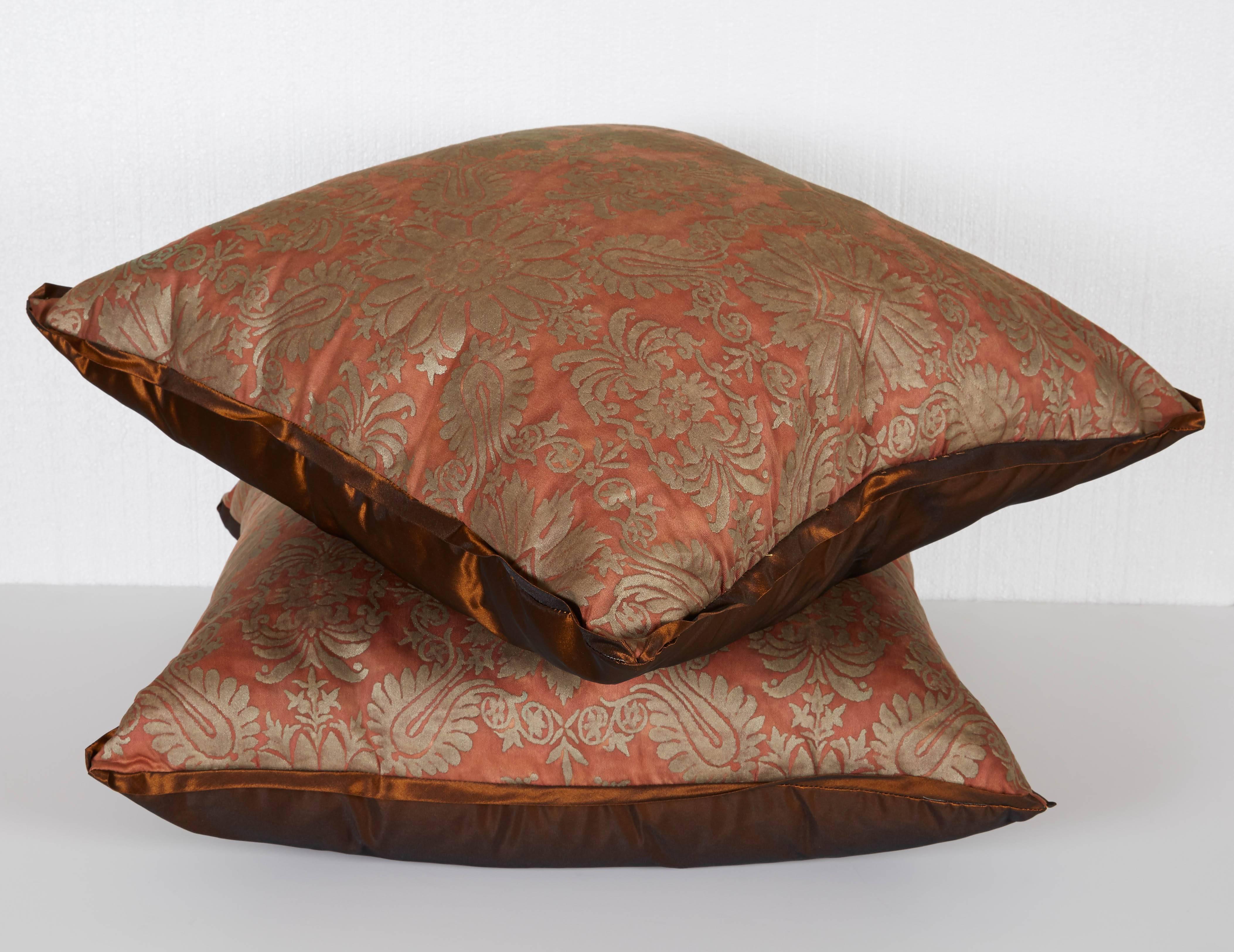 A pair of Fortuny fabric cushions in the Impero pattern, rust taffeta backing, red and silver color way, the pattern, a 19th century Empire motif
Newly made using vintage Fortuny fabric, circa 1920
50 down/50 feather insert.