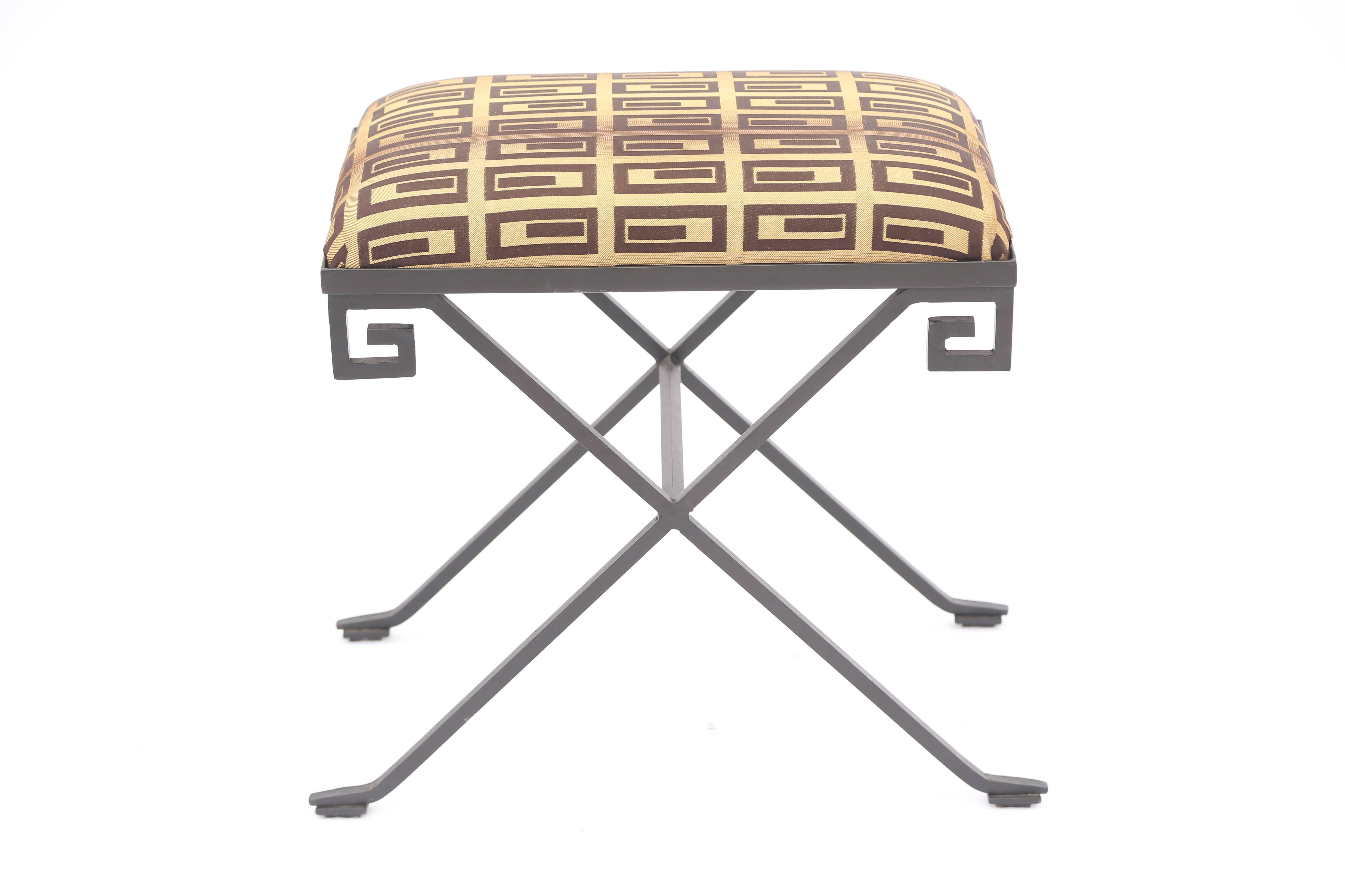 Black iron stool, in the style of Jean-Michel Frank, having Greek Key design at each corner, X-legs connected by stretcher; seat with custom upholstery. Stamped 