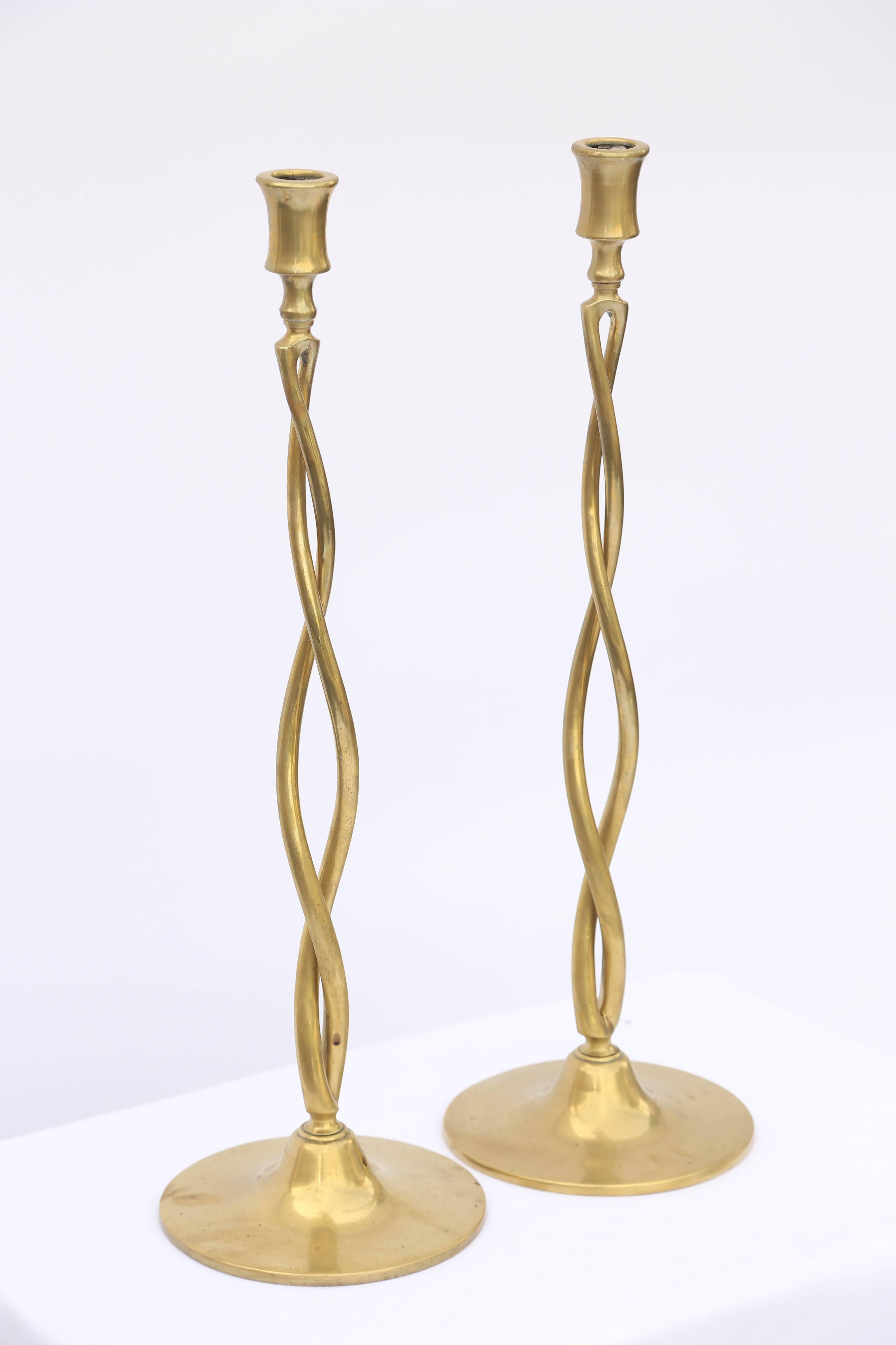 Pair of tall brass candlesticks, each having pierced braided column raised on round weighted base.

Stock ID: D6476